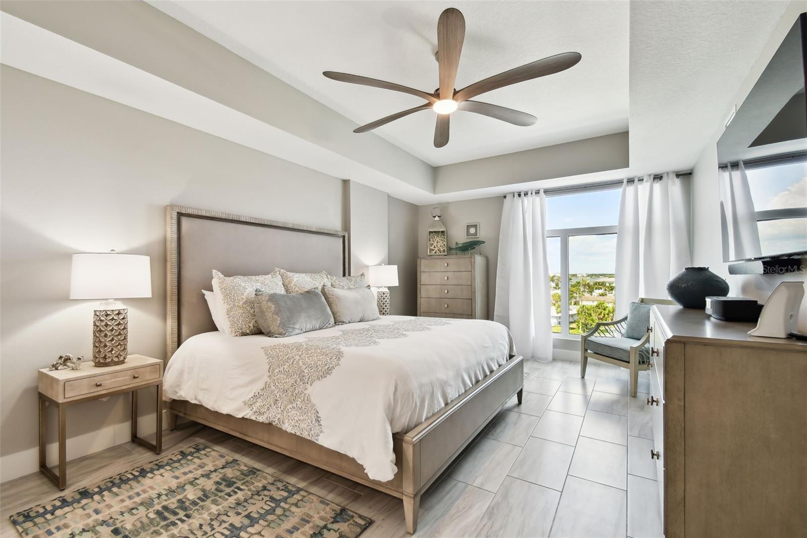 Primary Bedroom; overlooking the water with motorized window treatments