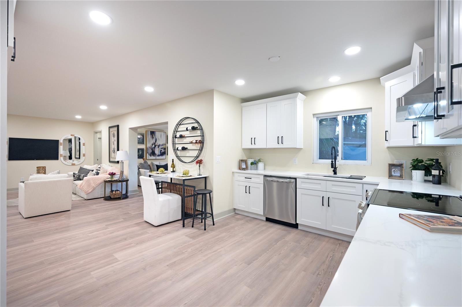 Kitchen open to family room and sunroom.