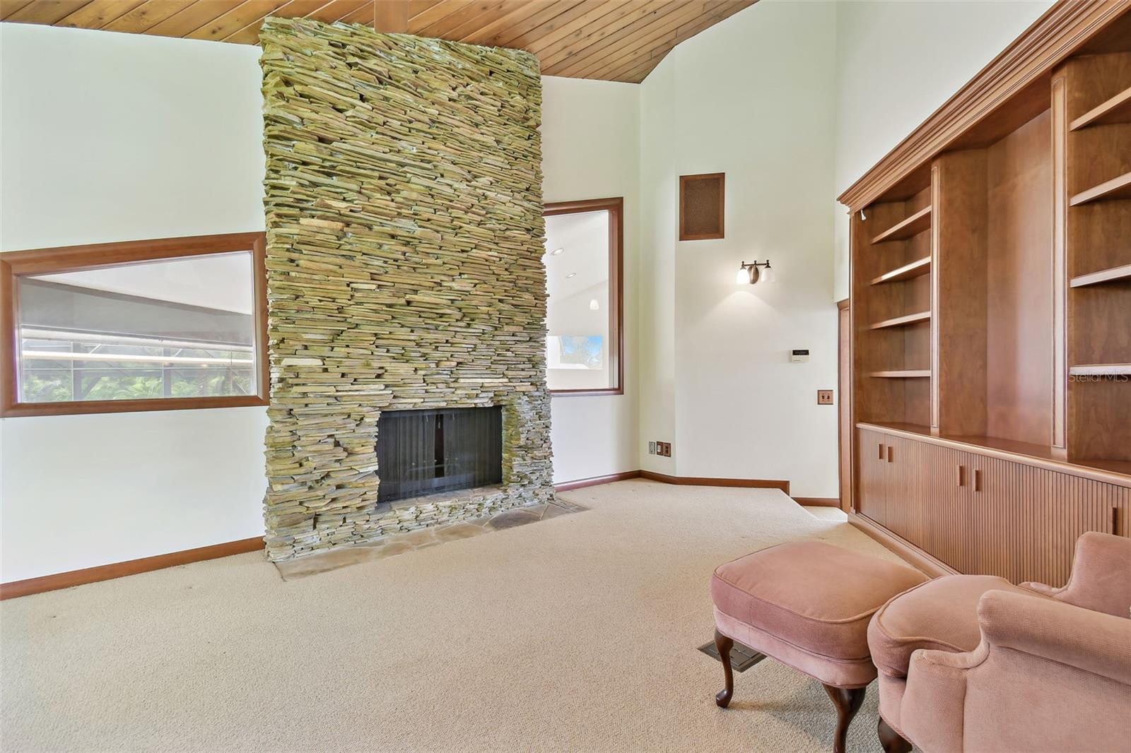Floor to ceiling stacked stone fireplace in the primary suite