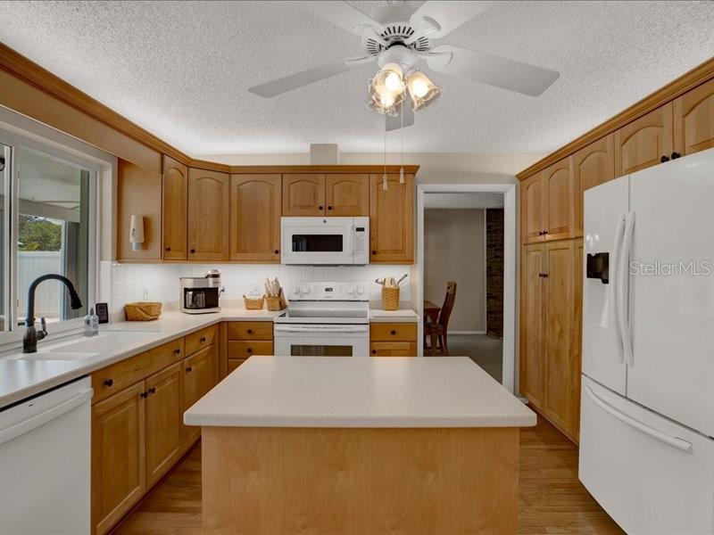 Lots of beautiful cabinets and a portable island