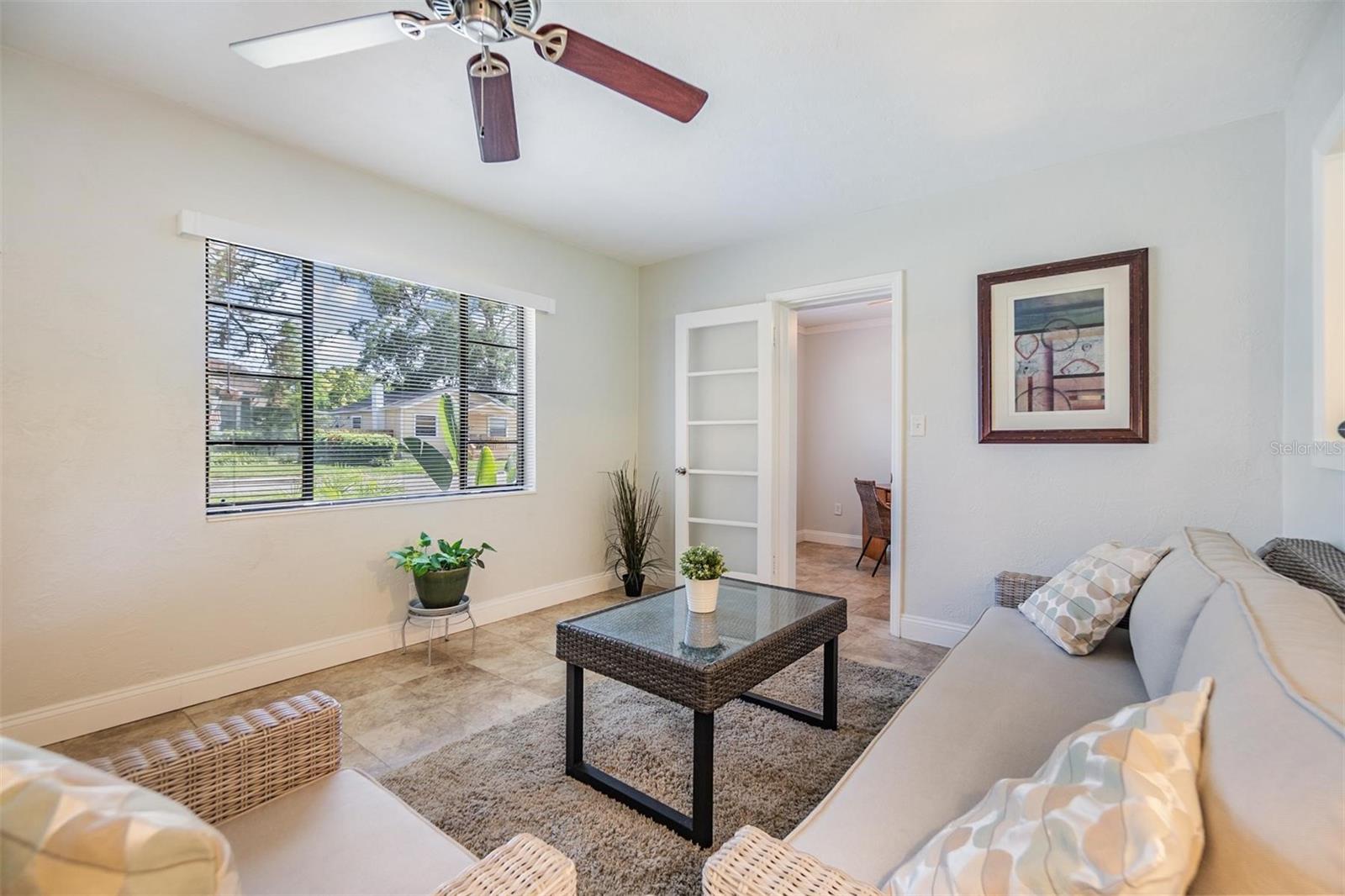 Living room w/ door to den/office