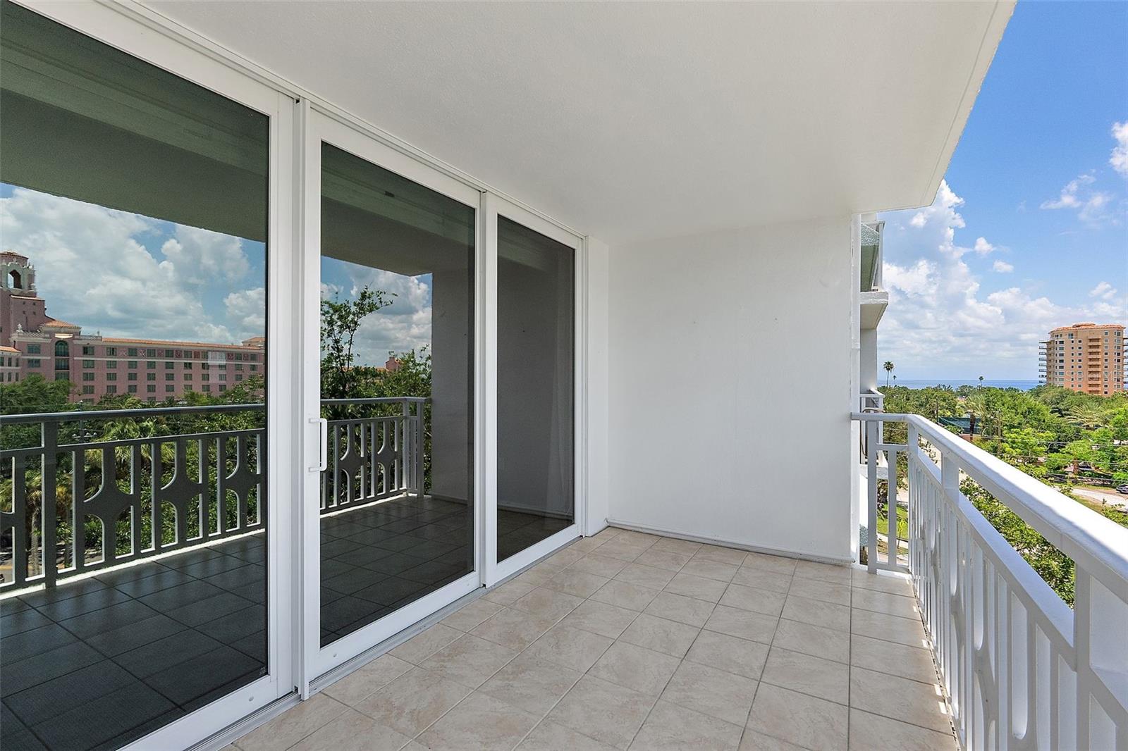 LARGE UPDATED IMPACT WINDOWS LEADING TO BALCONY