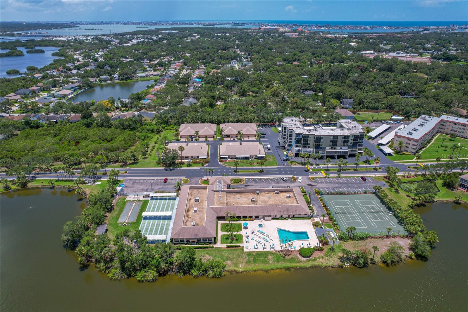 Recreation center's proximity to condo unit building, directly across from tennis/pickleball courts
