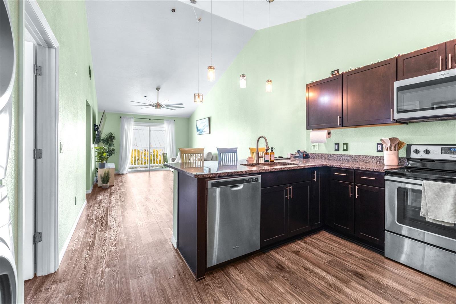 Open floor plan combining kitchen, living room, and dining area