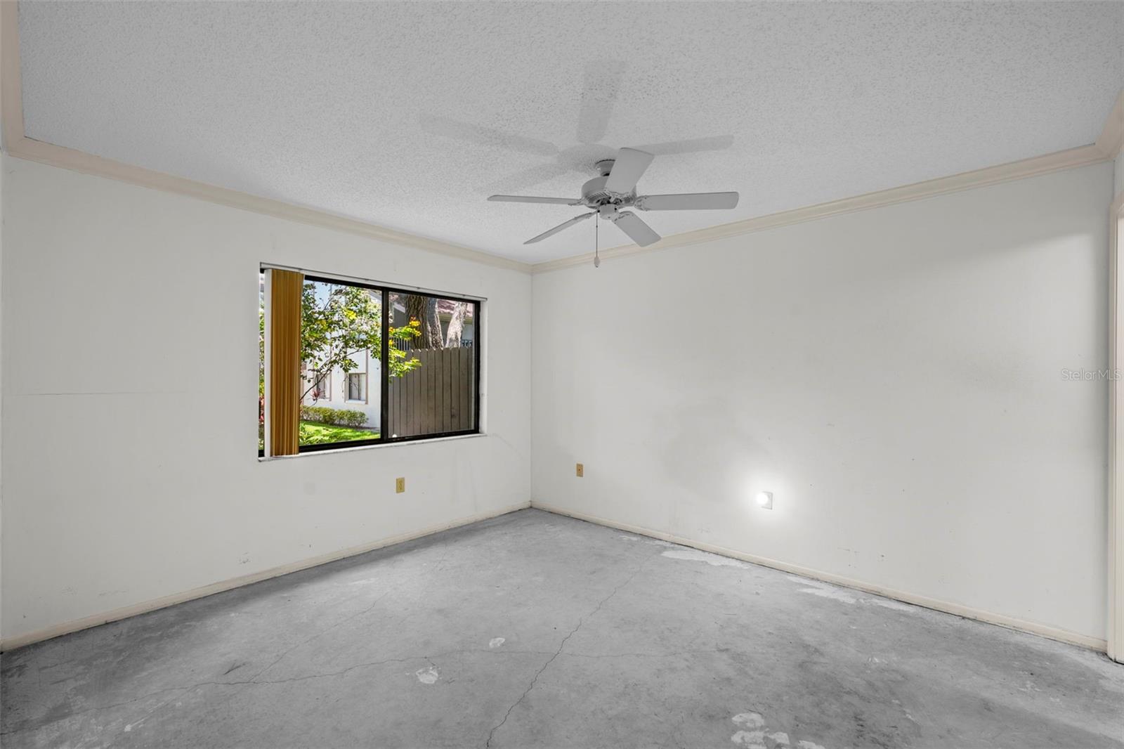 Primary bedroom with view of lovely backyard.