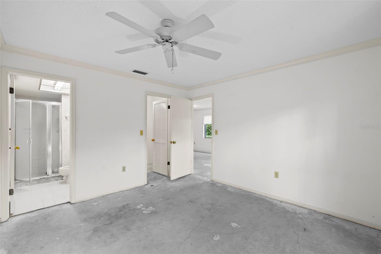 View of primary bedroom, mater bath, and walk-in closet.