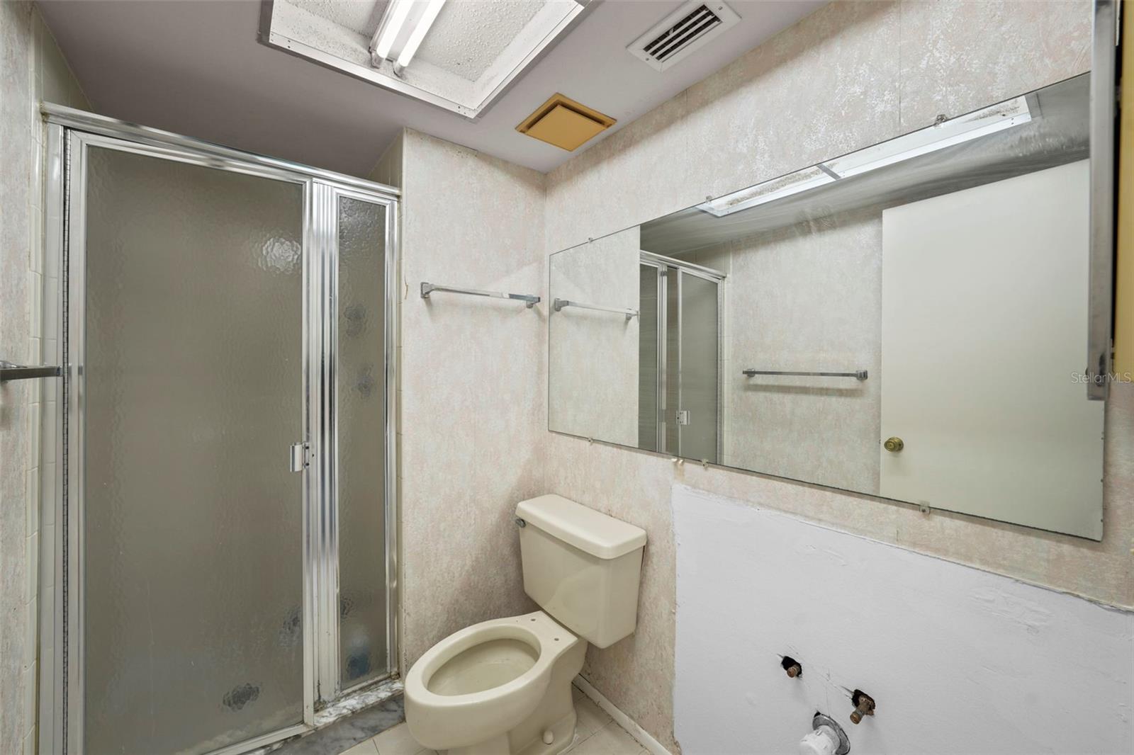 Master bath - insert inexpensive bathroom vanity combo with granite countertops -- very affordable at Costco, Lowe's.  Home priced so you can do this!