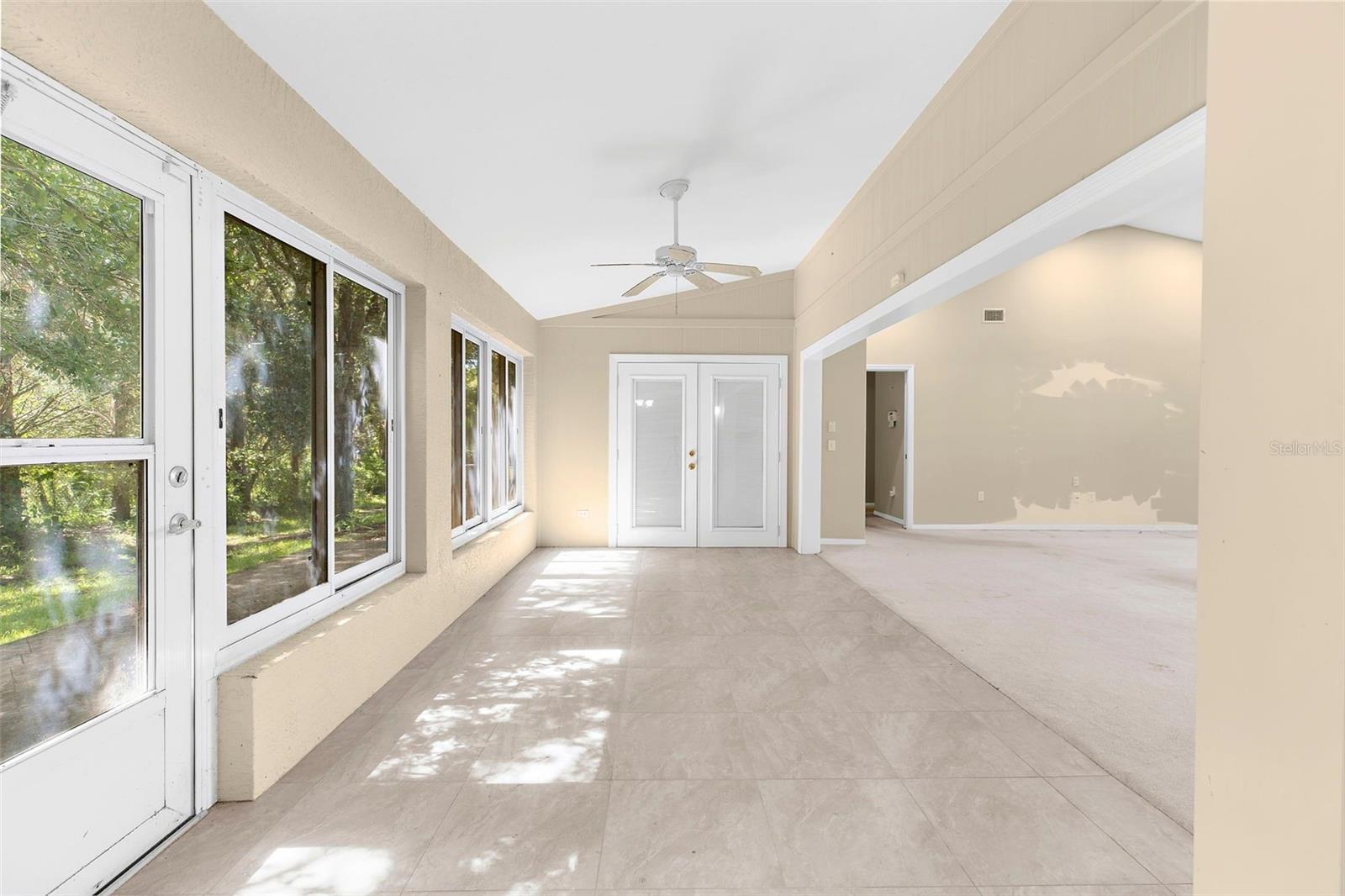 rear sun room enclosed and opens up living area