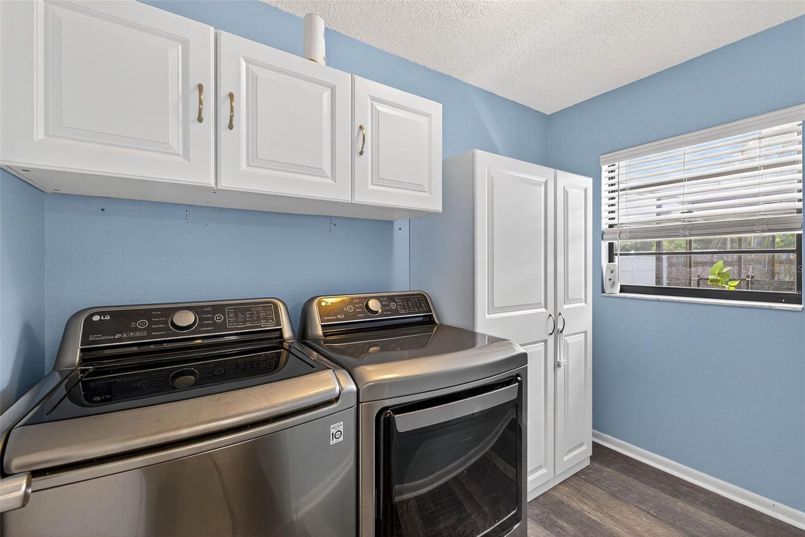 Laundry Room with cabinets, washer, and dryer