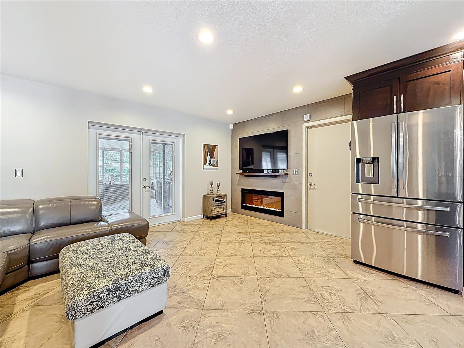 TV nook in kitchen area with built in electric fireplace, TV and surround sound system