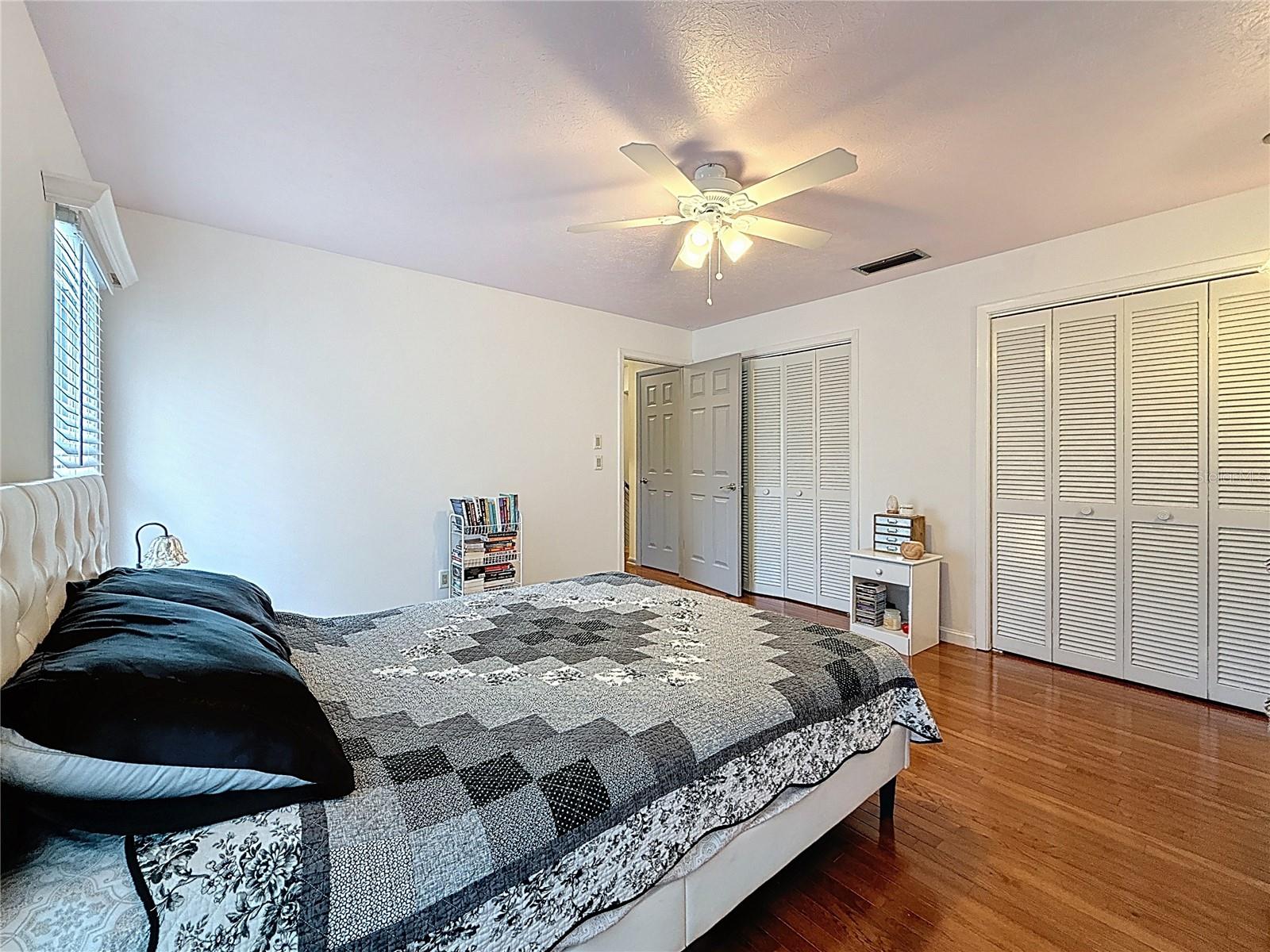 2nd bedroom with wooden floor and lots of closet space