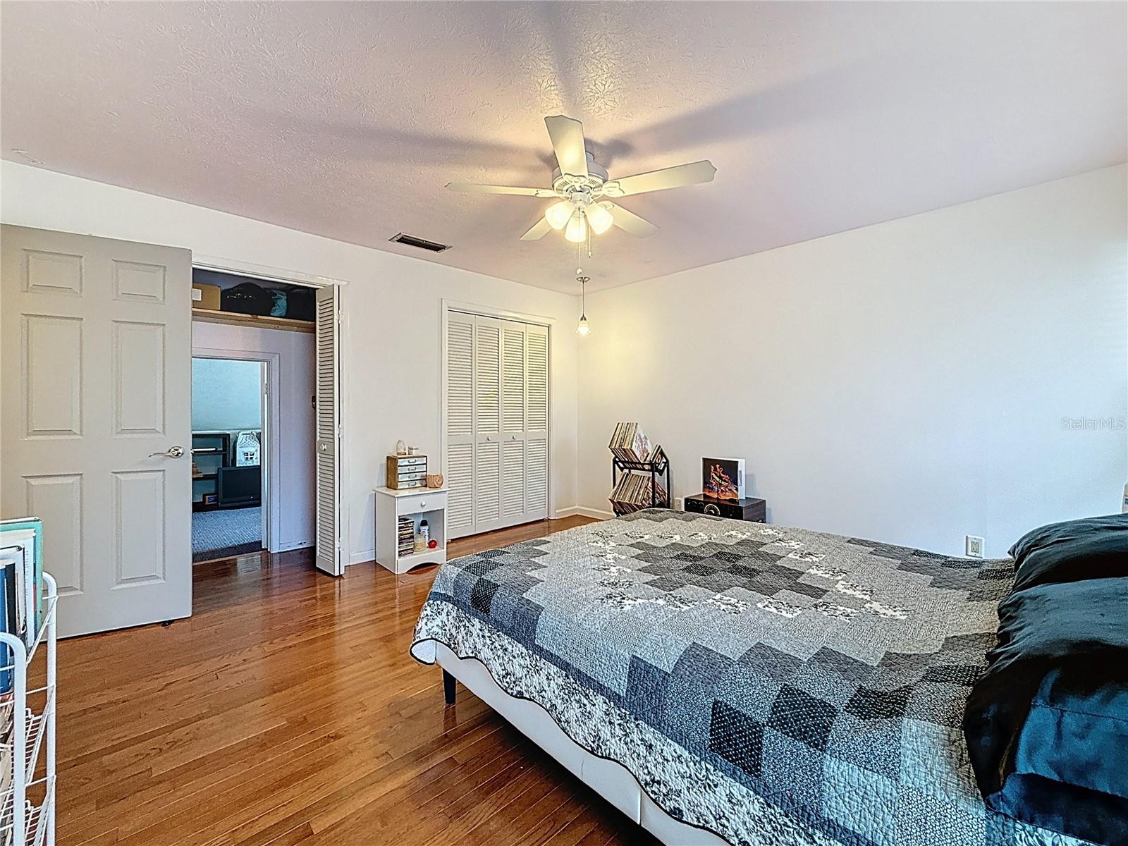 2nd bedroom with wooden floor and lots of closet space