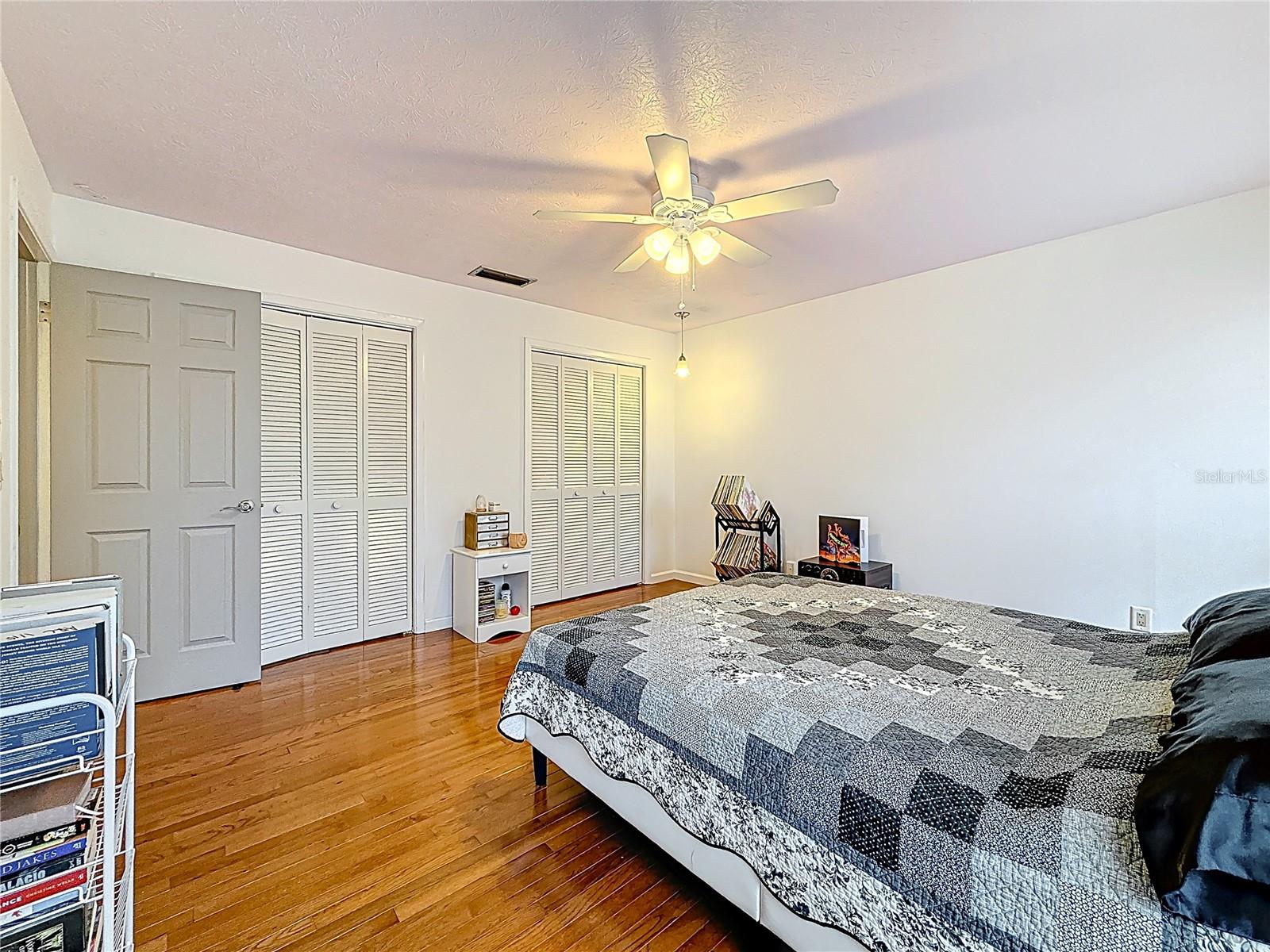 2nd bedroom with wooden floor and lots of closet space