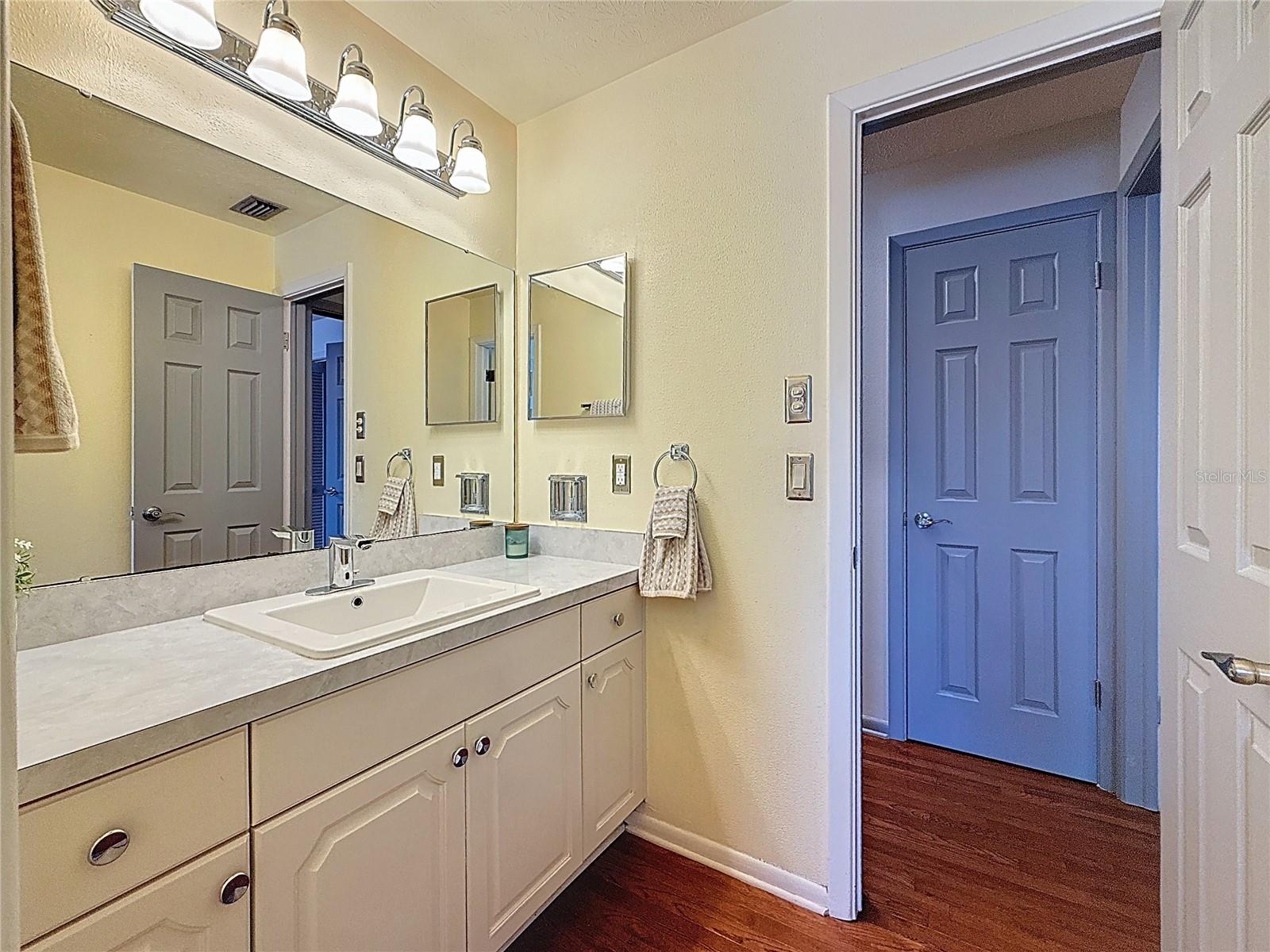 Second bathroom with tub shower and overhead heating lamp