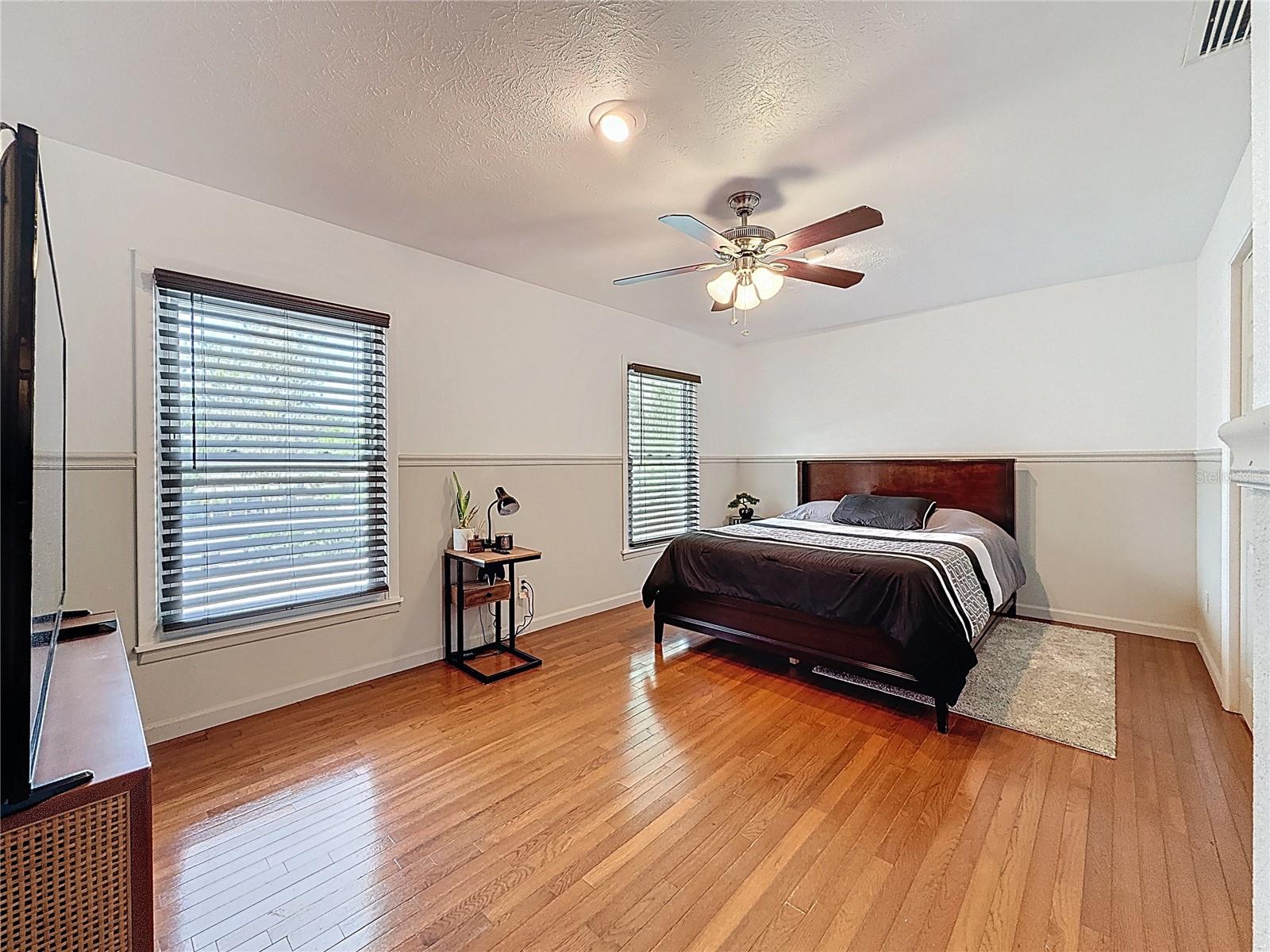 3rd bedroom with wood floor and walk in closet