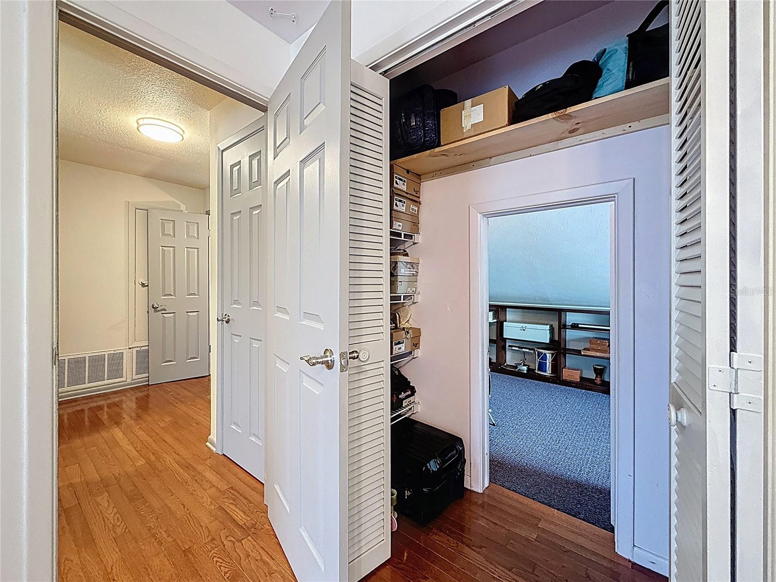 3rd bedroom with wood floor and walk in closet