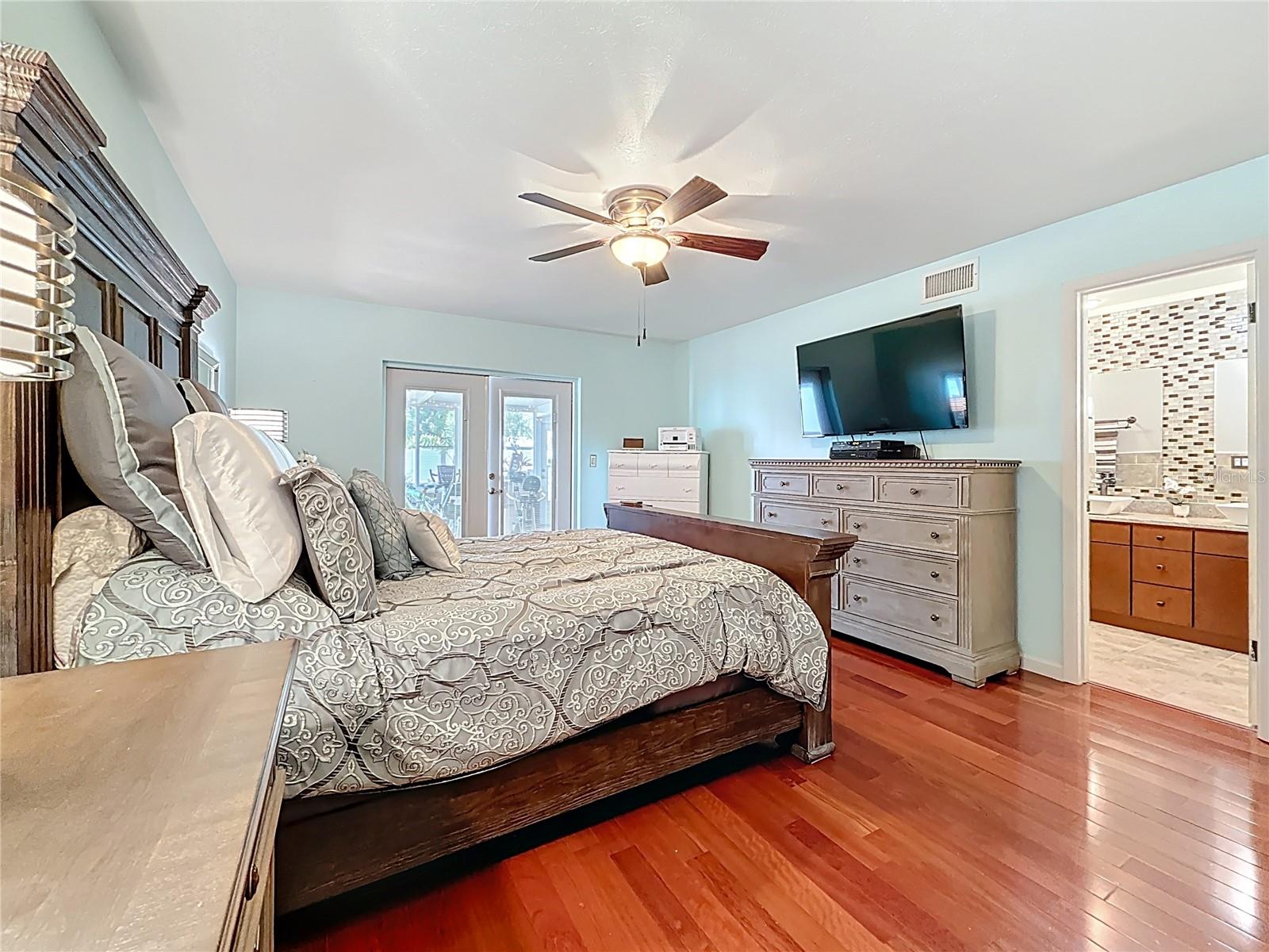 Downstairs master bedroom suite with wood floor