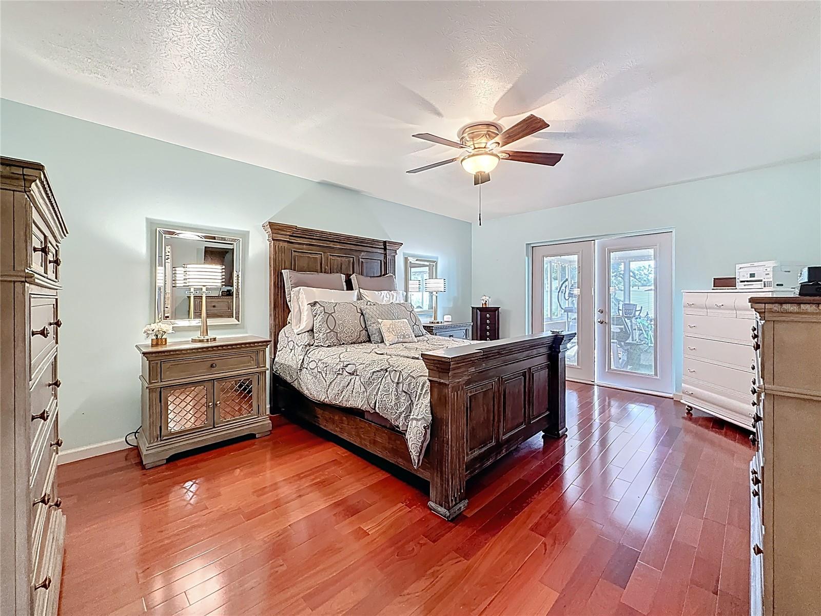 Downstairs master bedroom suite with wood floor
