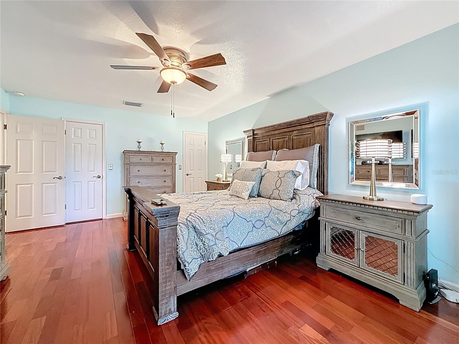 Downstairs master bedroom suite with wood floor