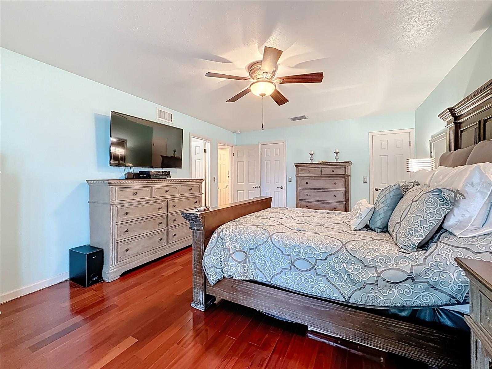 Downstairs master bedroom suite with wood floor