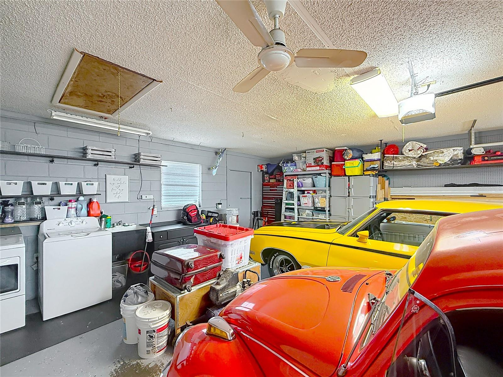 2-car garage with shelving and work bench and hurricane rated door with Wi-Fi controlled door opener