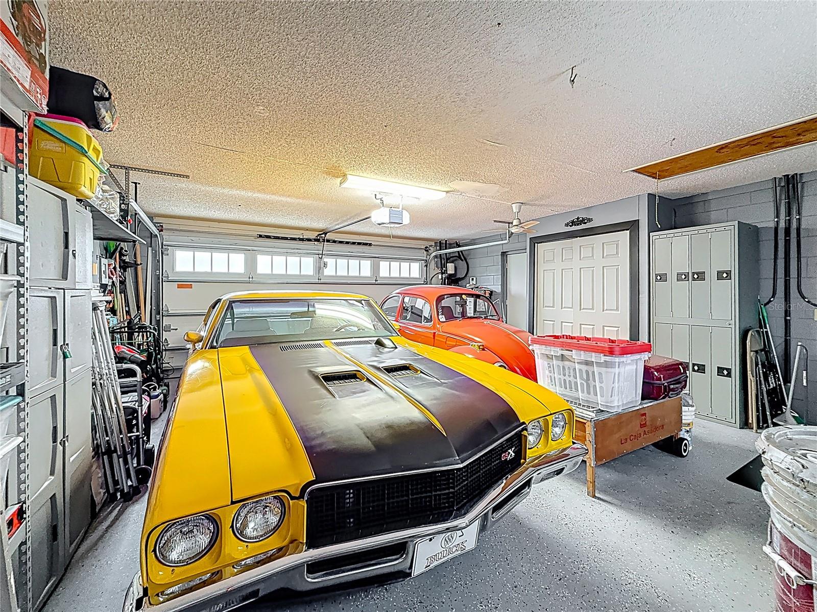 2-car garage with shelving and work bench and hurricane rated door with Wi-Fi controlled door opener