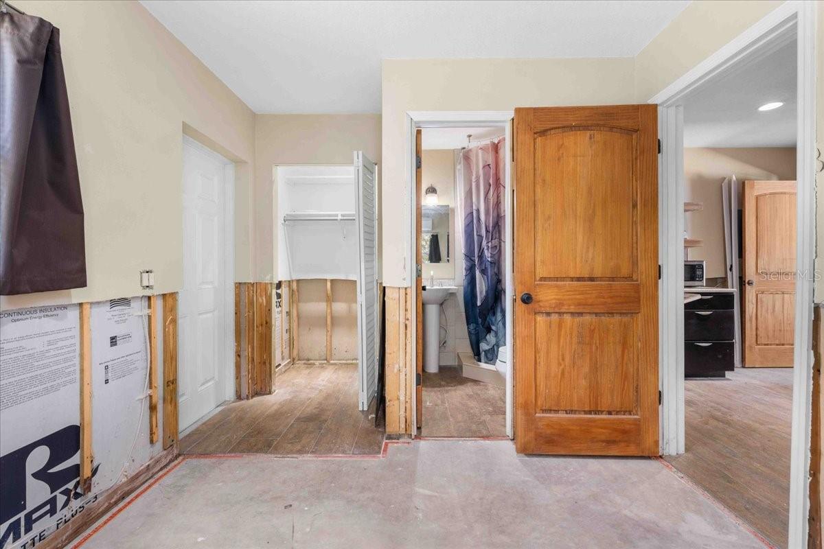 In-law suite showcasing the bedroom, the closet and the full bathroom, one private entry directly outside (left wall)