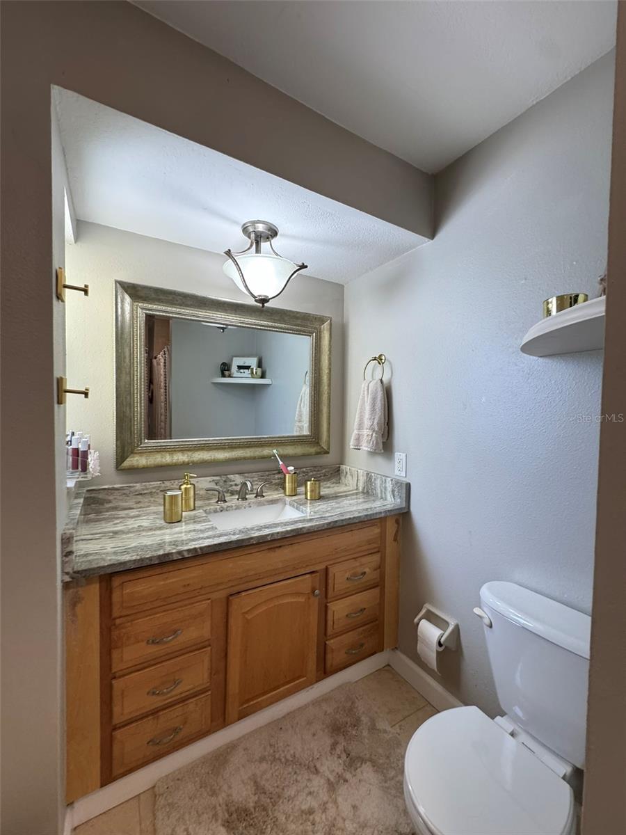 full bath with dual vanity and tub