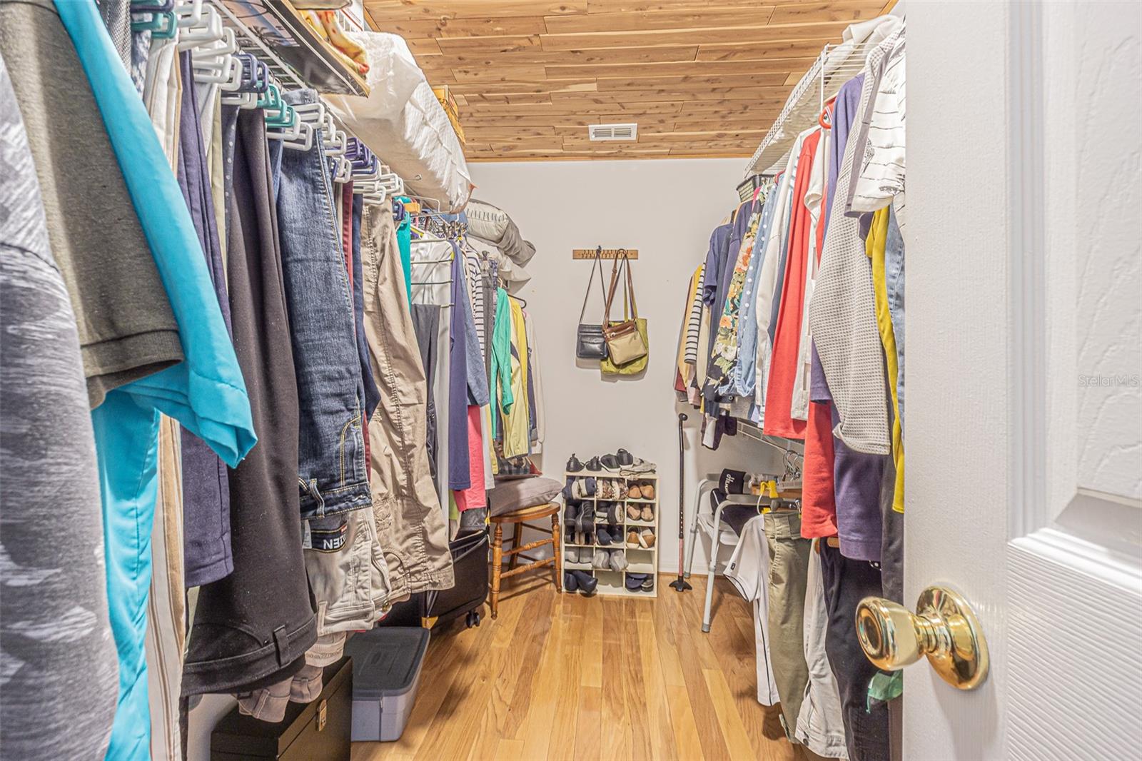 Walk-In Closet With Cedar Ceiling In Primary Bedroom