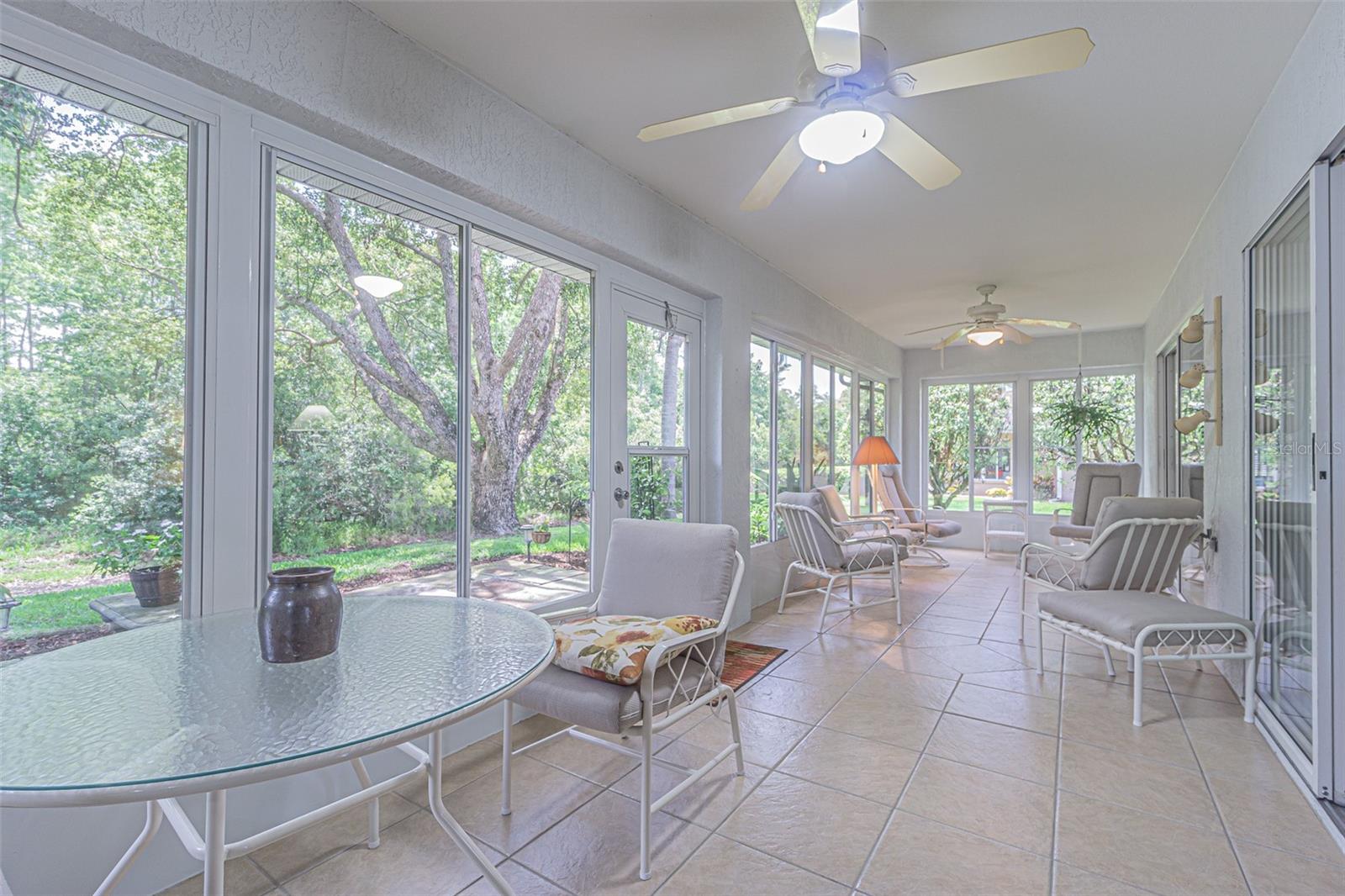 Check Out This Huge Lanai with Glass Windows and Ceramic Tile.