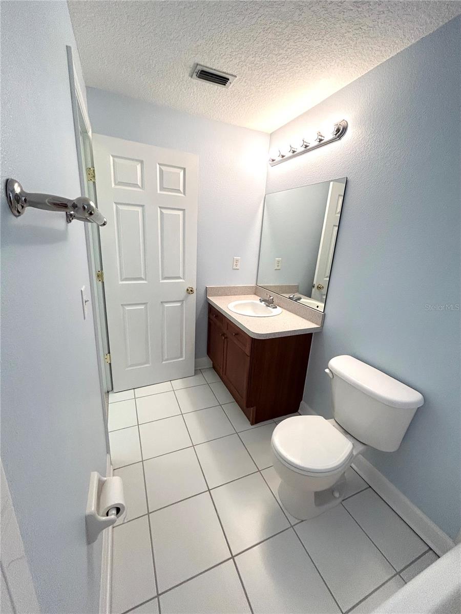 Step into a refreshing escape with sleek white tiles and cool blue-gray walls that create a clean, calming vibe. This inviting bathroom blends simplicity and serenity, making it the perfect place to start and end your day.