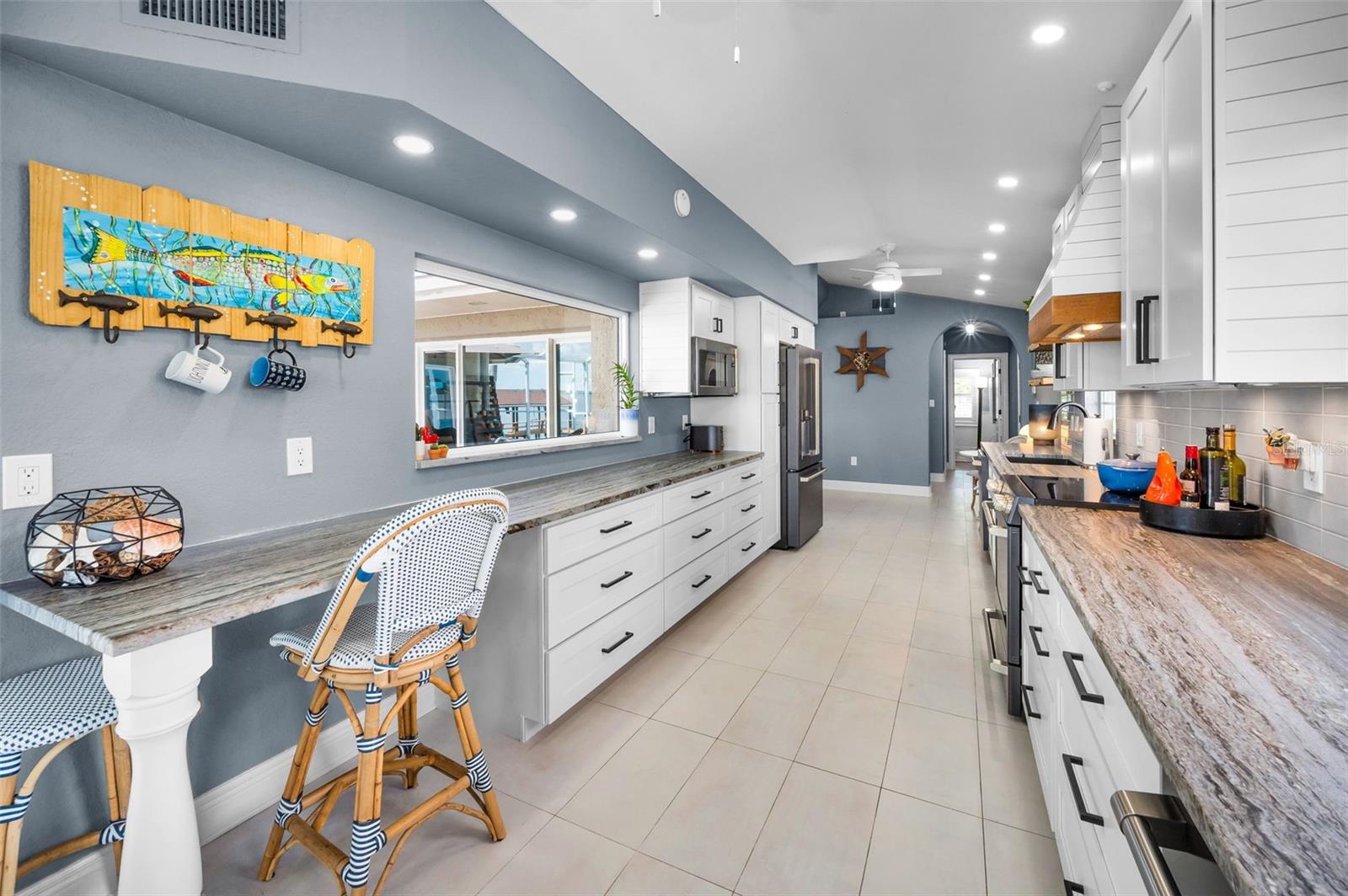 Fabulous kitchen with leather finished granite, shaker cabinets, custom range hood, GE Cafe matte appliances