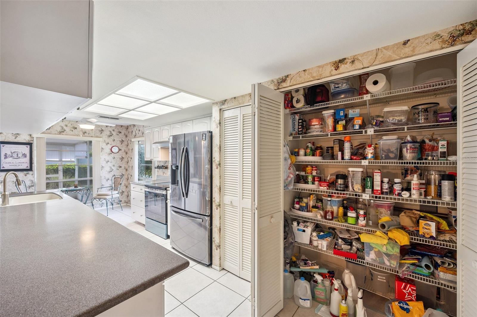 Kitchen with oversized patry closet as well as a smaller pantry to the left for overflow.