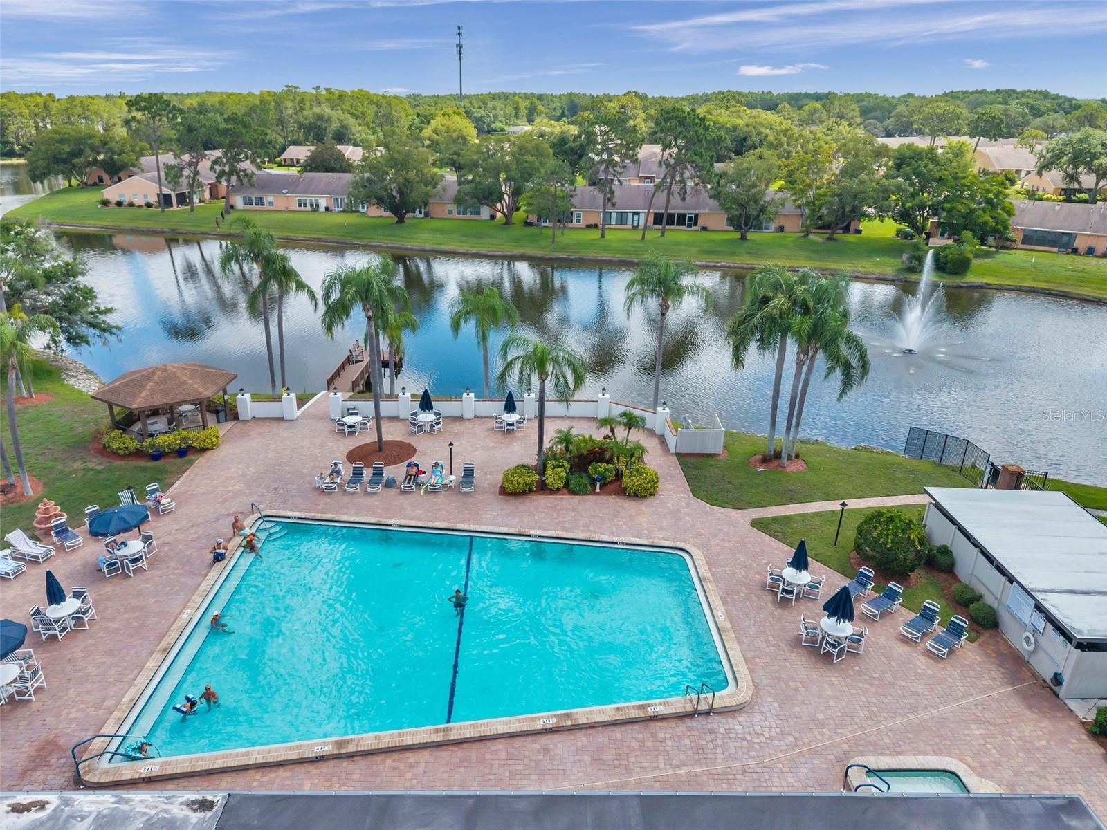 Heated pool with plenty of areas to sit or lounge around the pool
