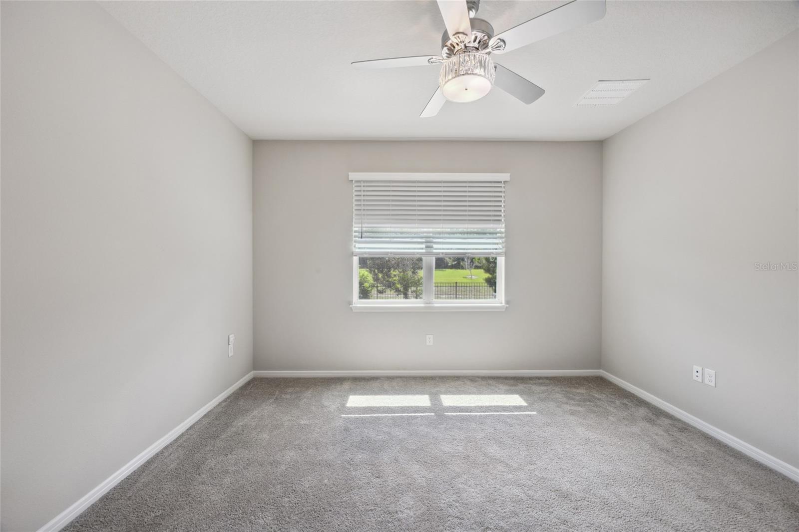 Primary Bedroom/Owners Suite overlooking beautiful views of serene backyard