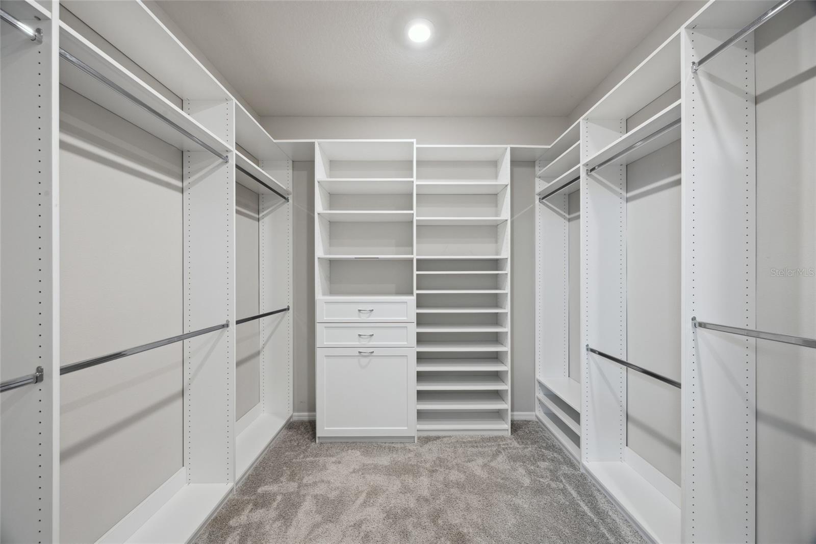 Custom designer walk in closet in Primary suite