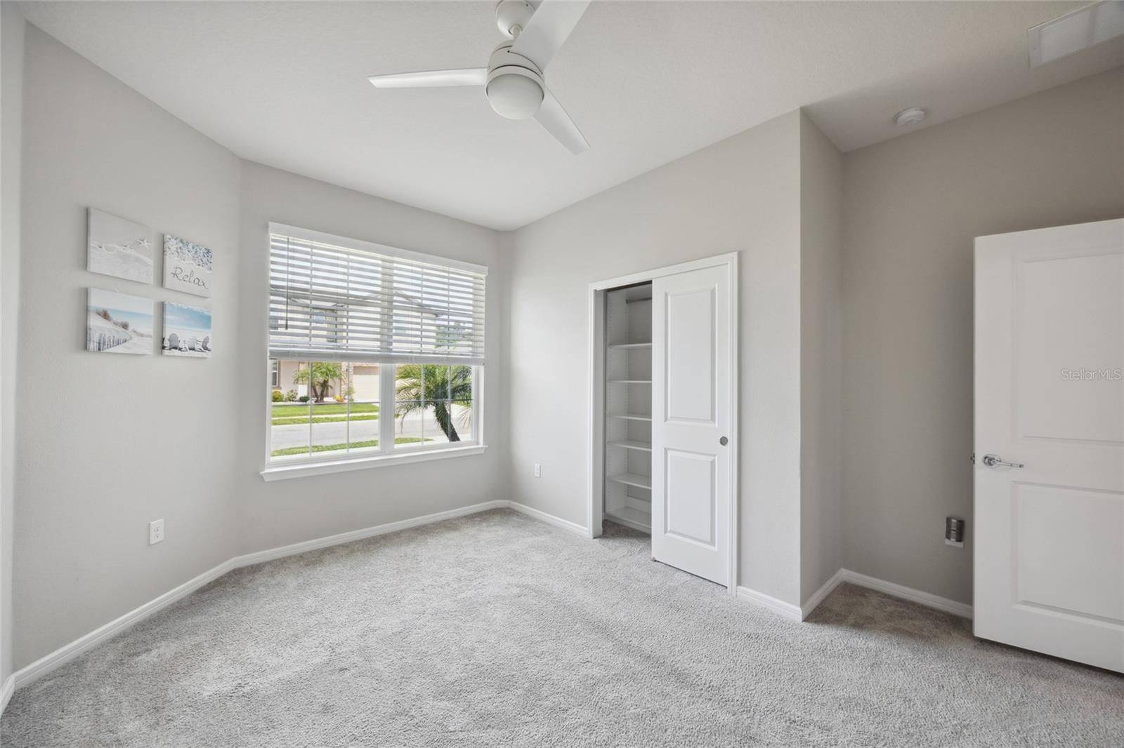 Bedroom 2 with beautiful baywindow , blinds, custom closets