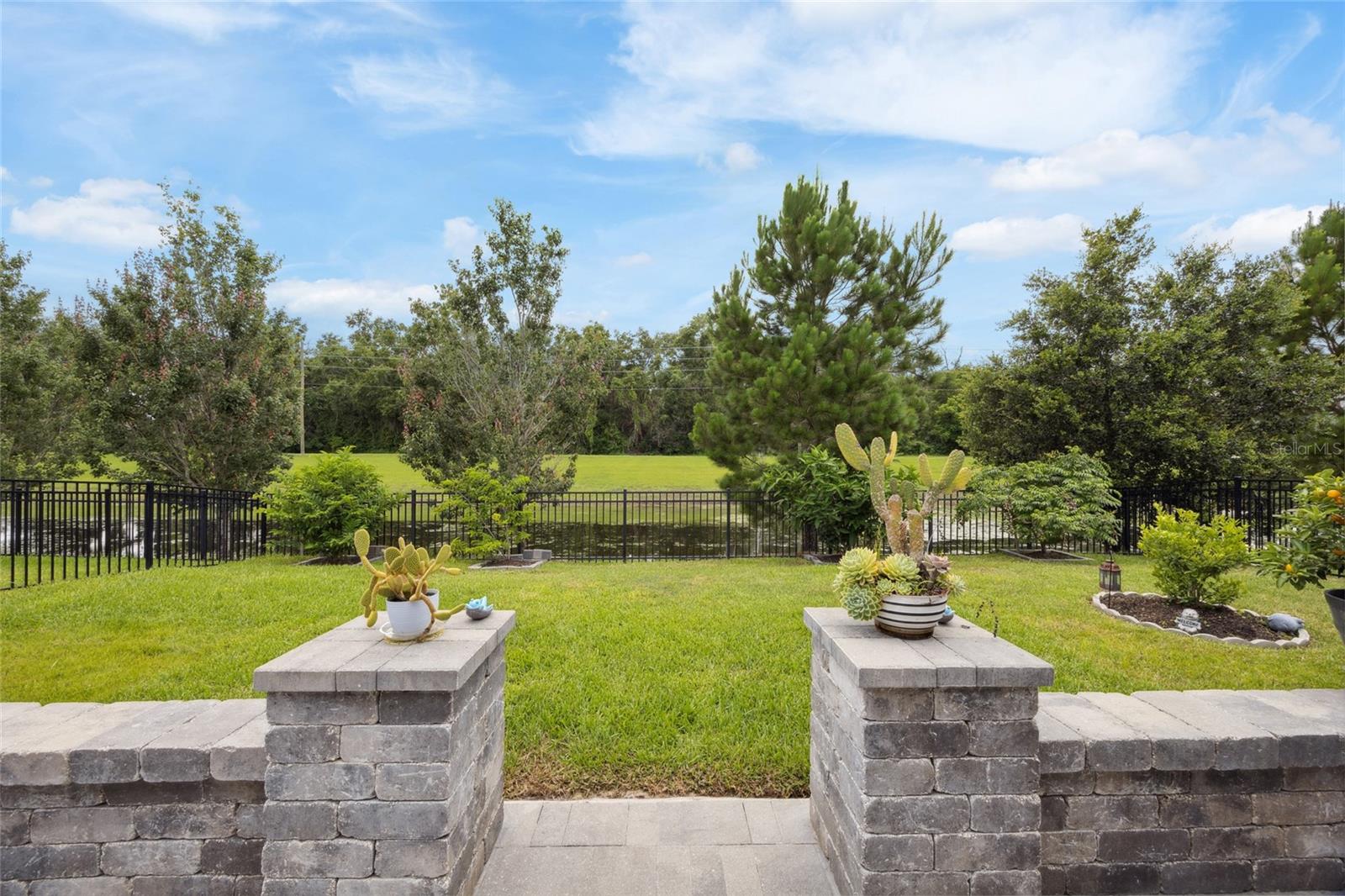 extended large custom patio with beautiful views of backyard