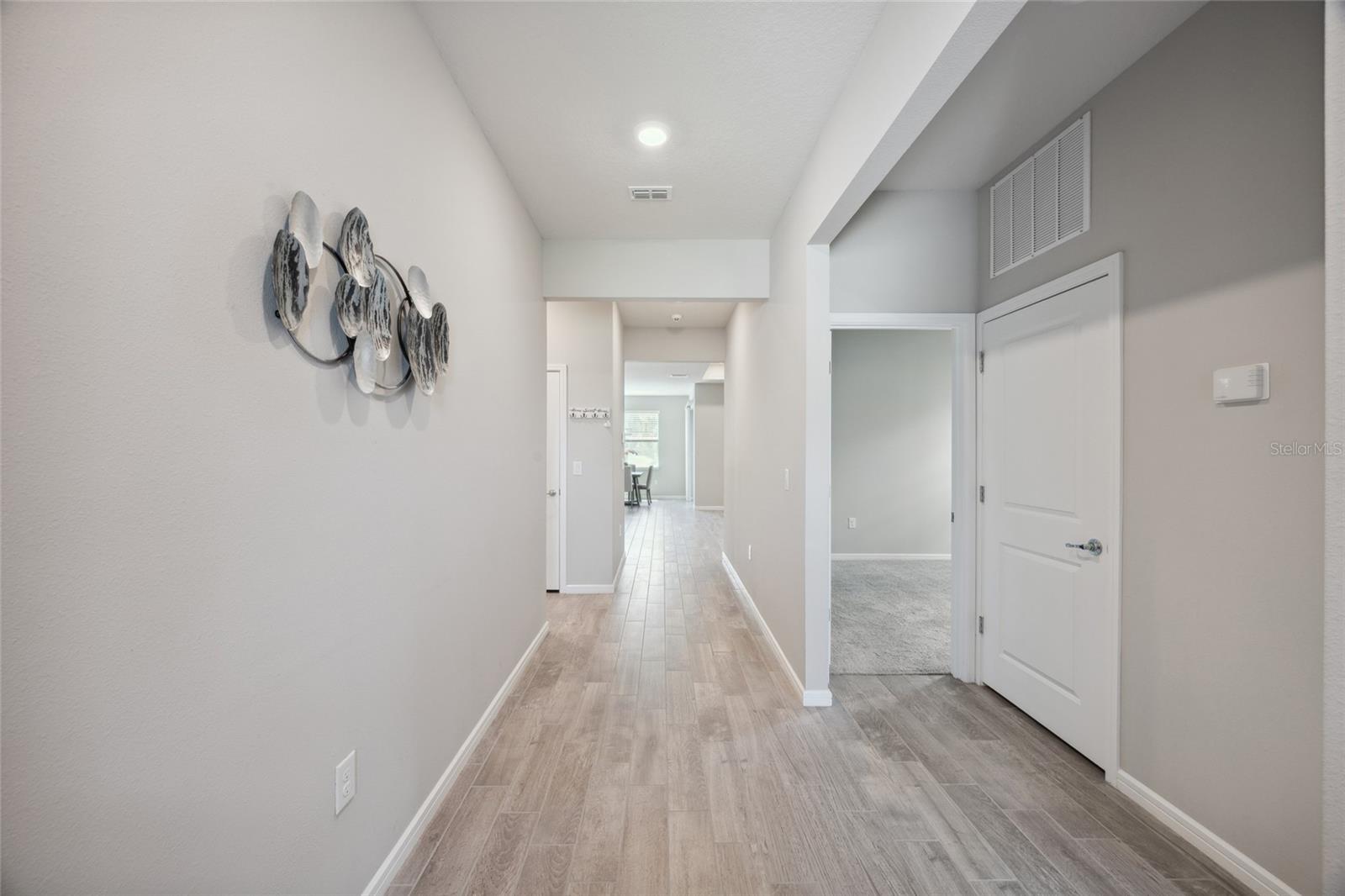 Foyer with beautiful grey designer tile throughout living area