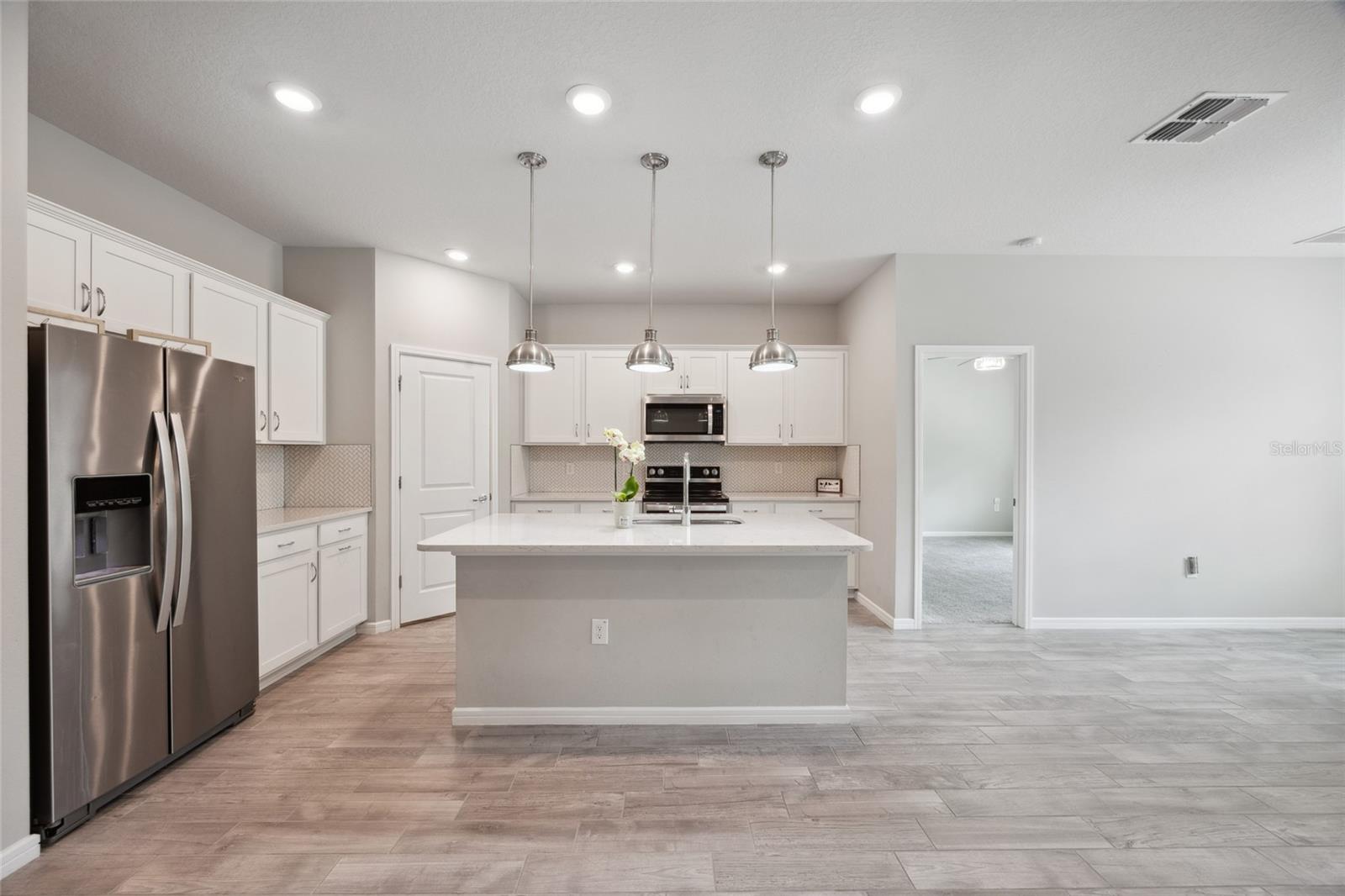 Kitchen with center island quartz counter tops