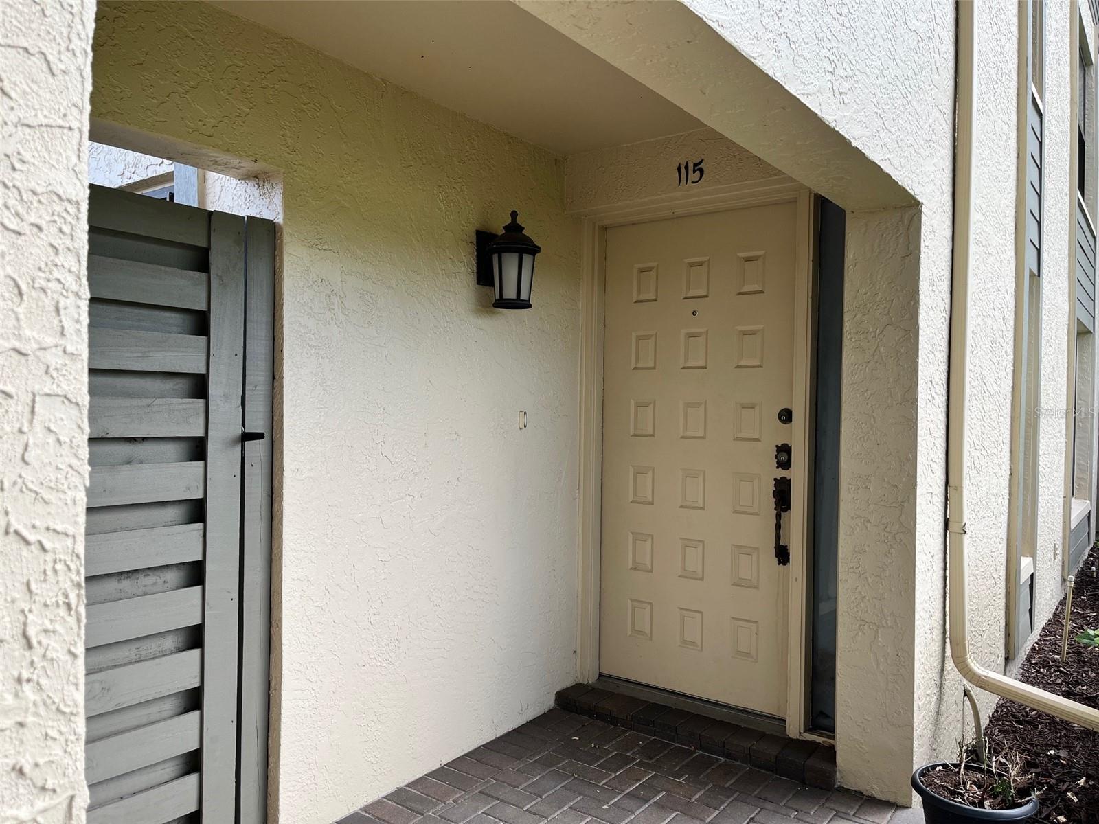 Main entrance and gate to side patio