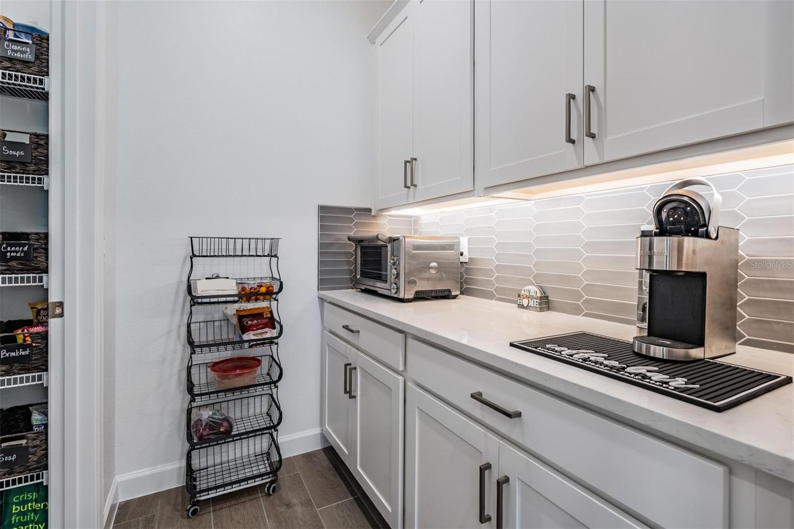 Butlers pantry with tons of cabinets & backsplash