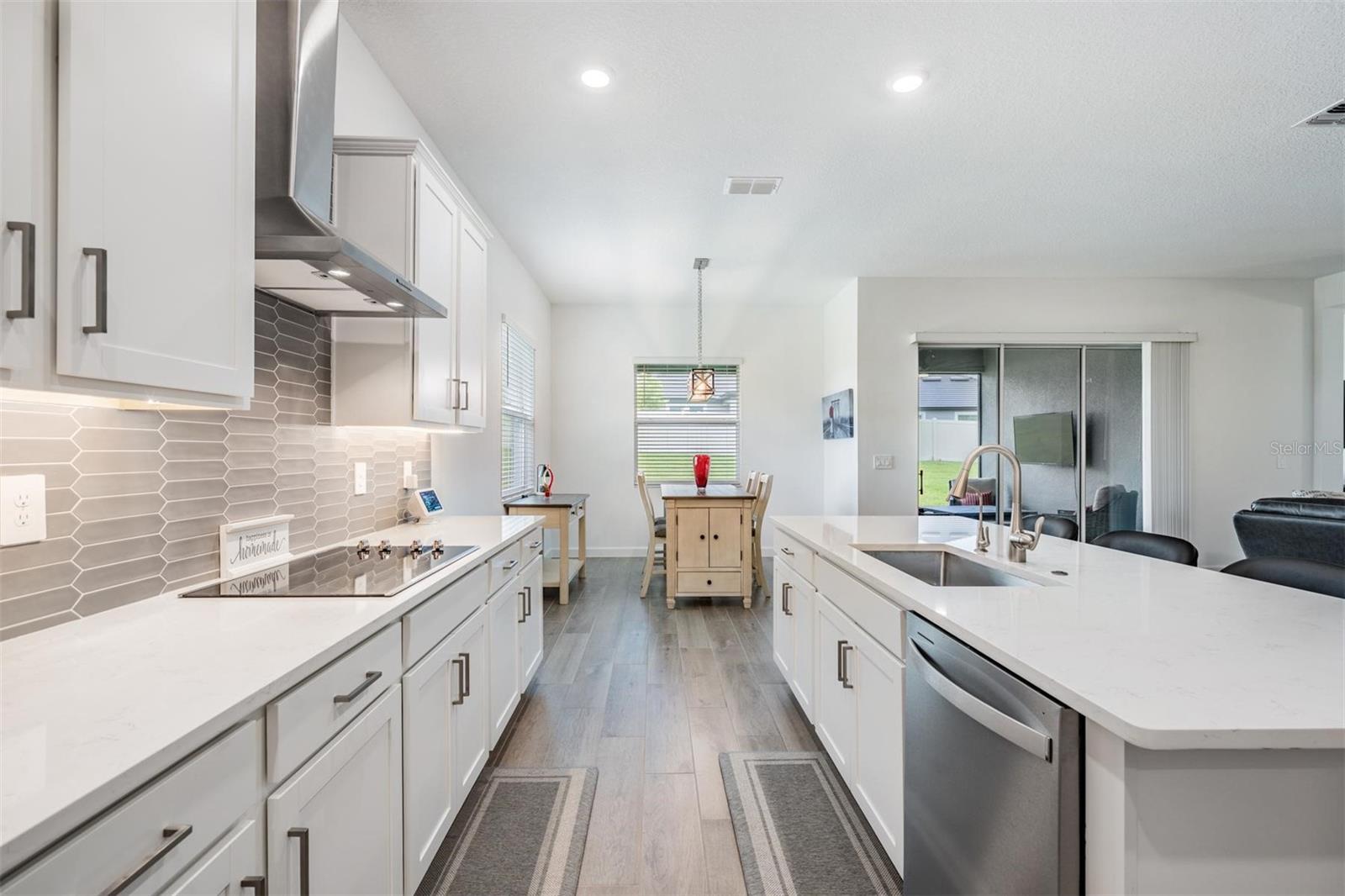 Quartz counters, stainless appliances, gorgeous backsplash!