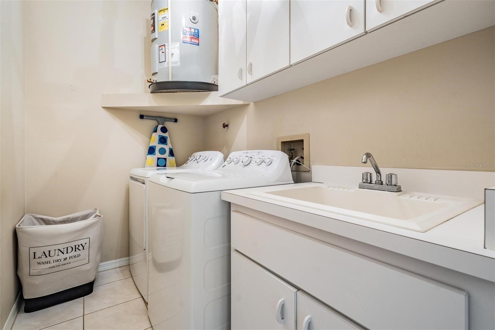 interior laundry room with cabinets