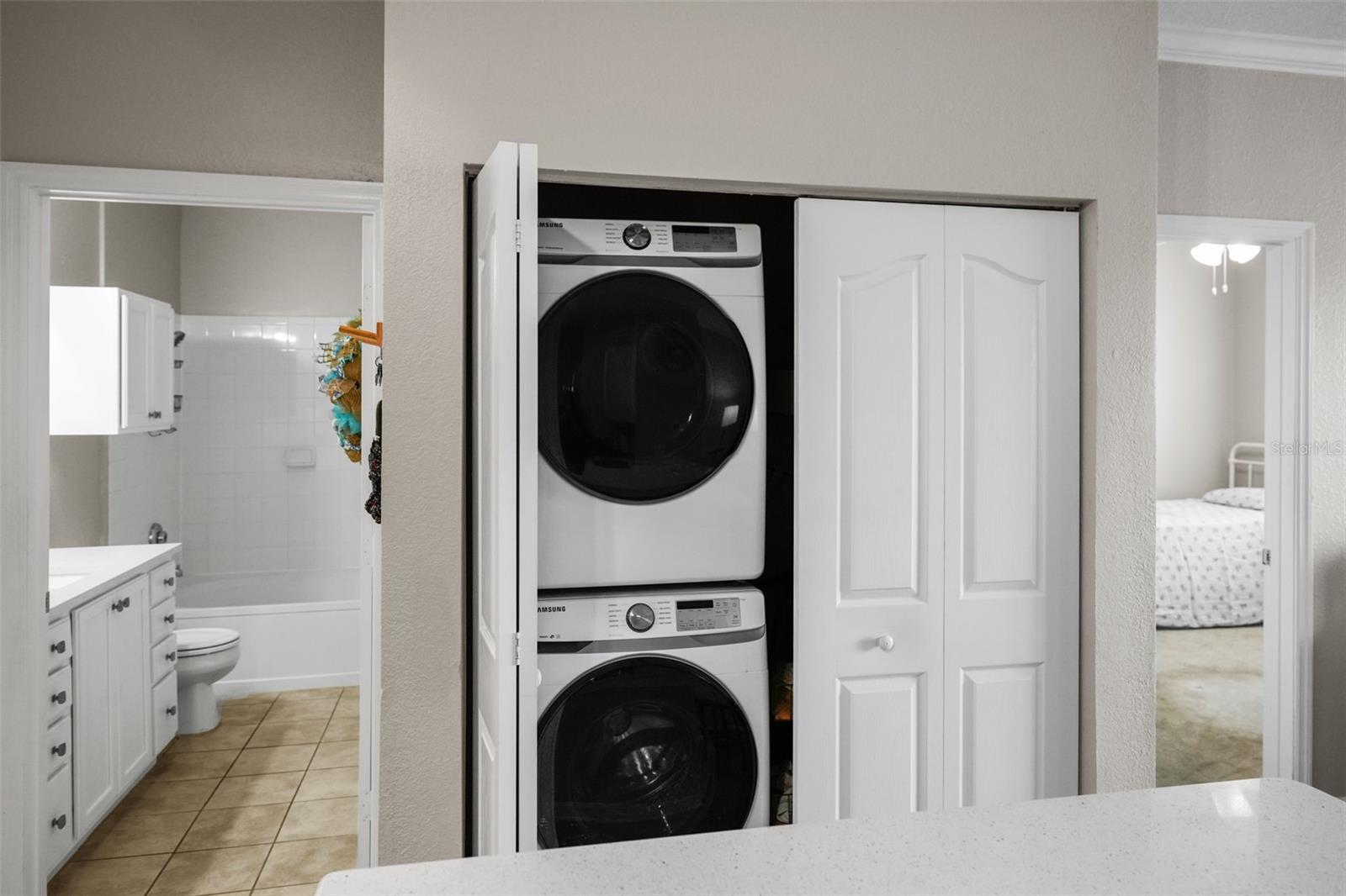 Convenient laundry closet with oversized stacked Washer & Dryer
