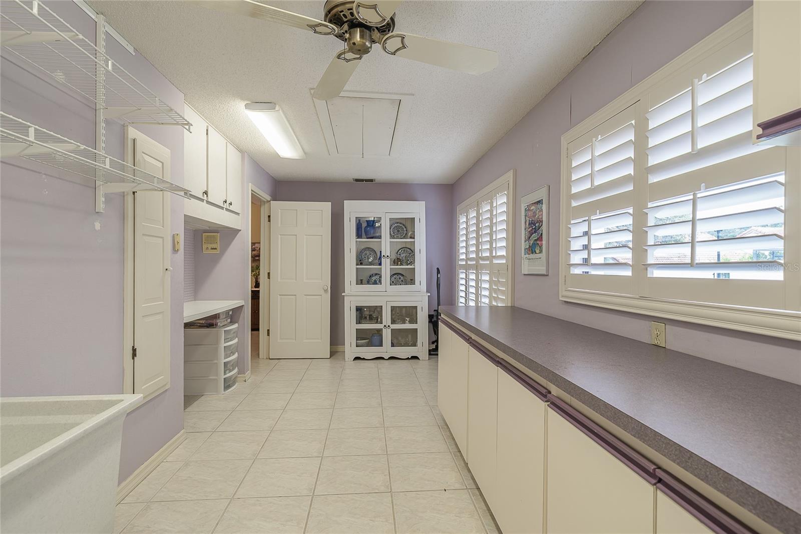 utility room, built in cabinets, ironing board and desk