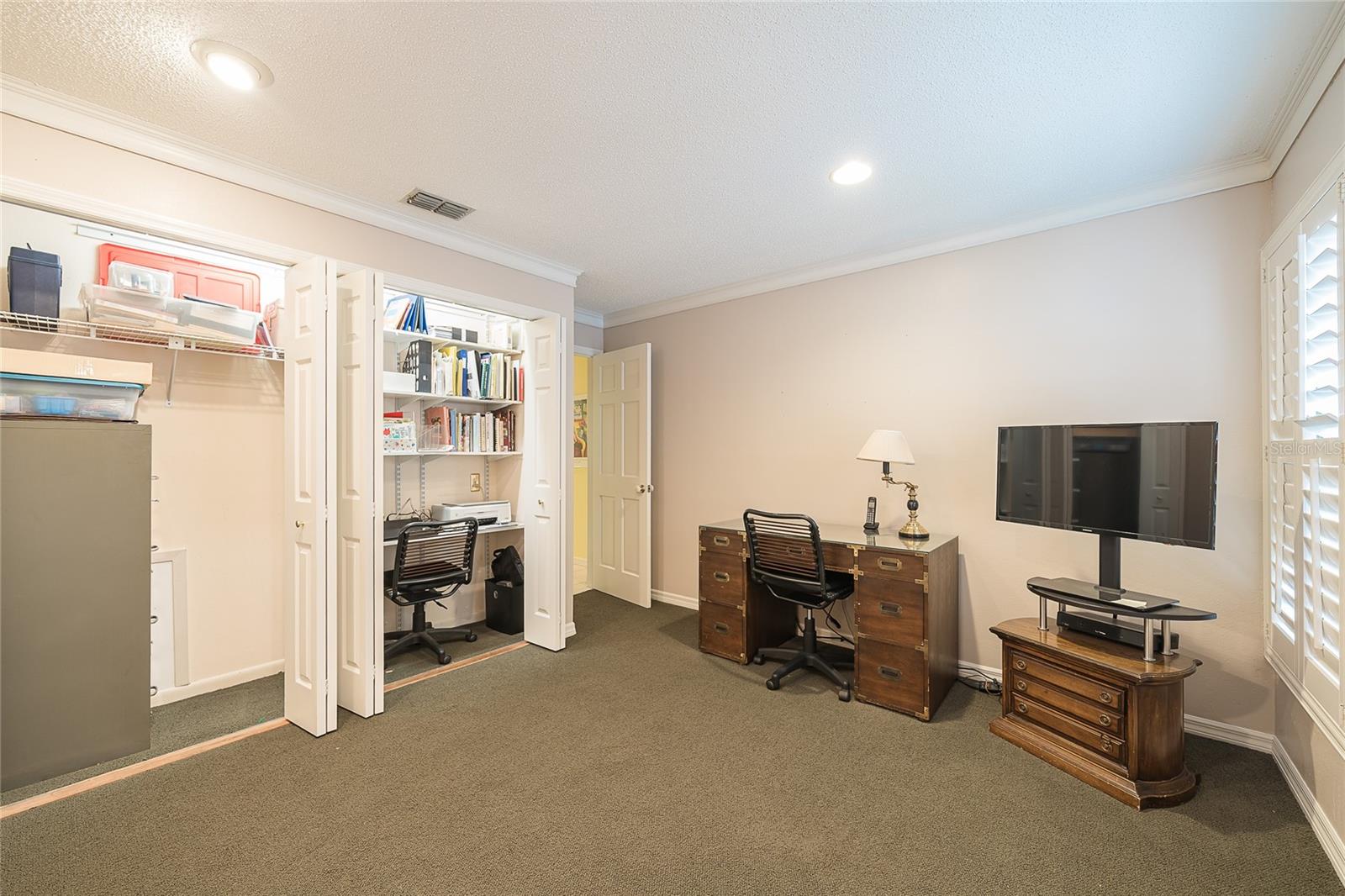 2nd bedroom with closet and built-in desk
