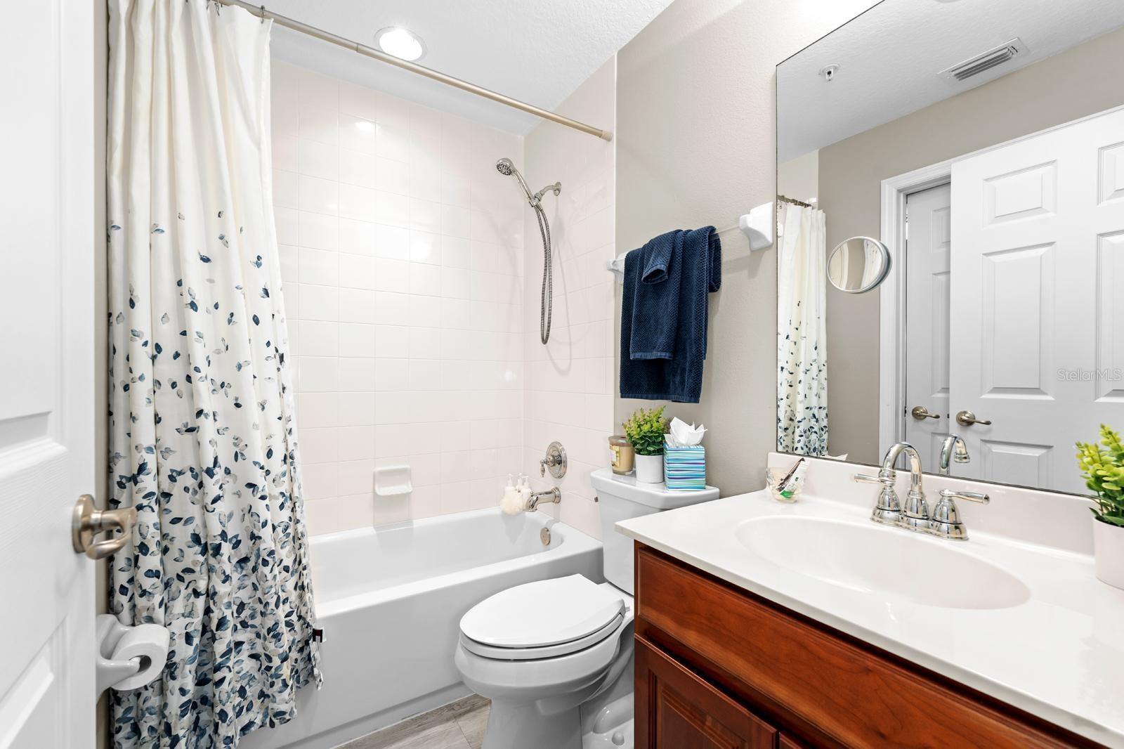 The second bathroom features a storage vanity and it is also the guest bathroom.