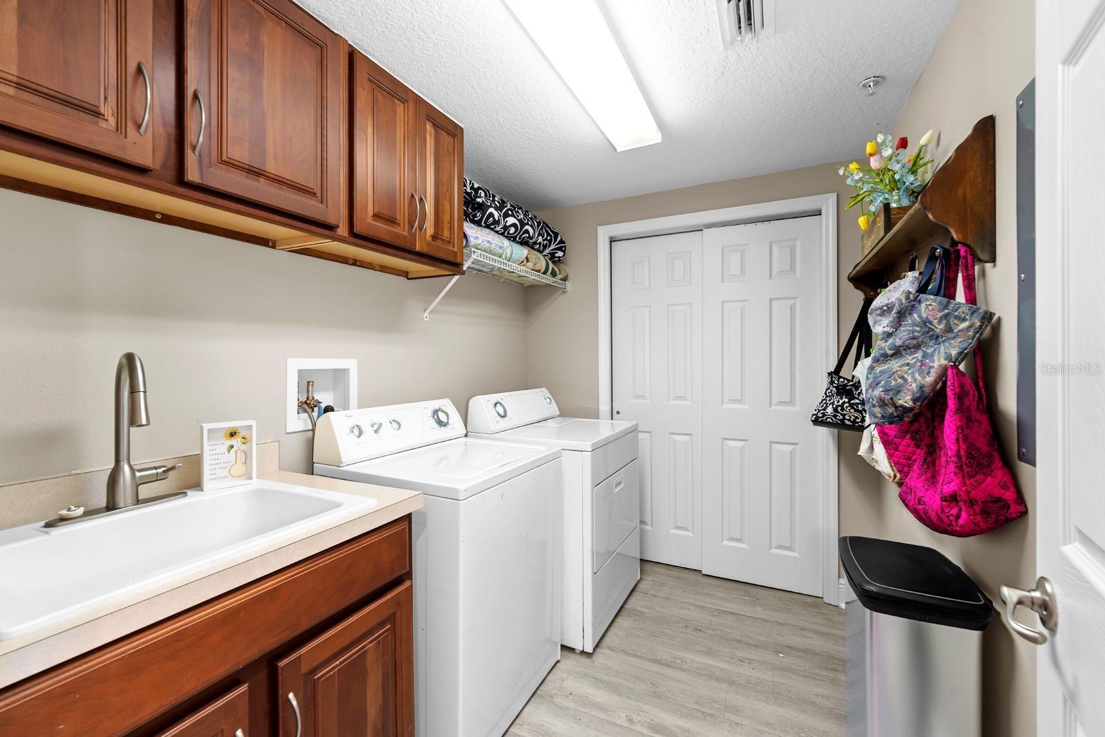 Don't you love the vanity storage sink, and the ample amount of storage cabinets? There's open shelving and space on the right for shelving or a folding table.  The closet houses the AC Handler and the hot water heater.