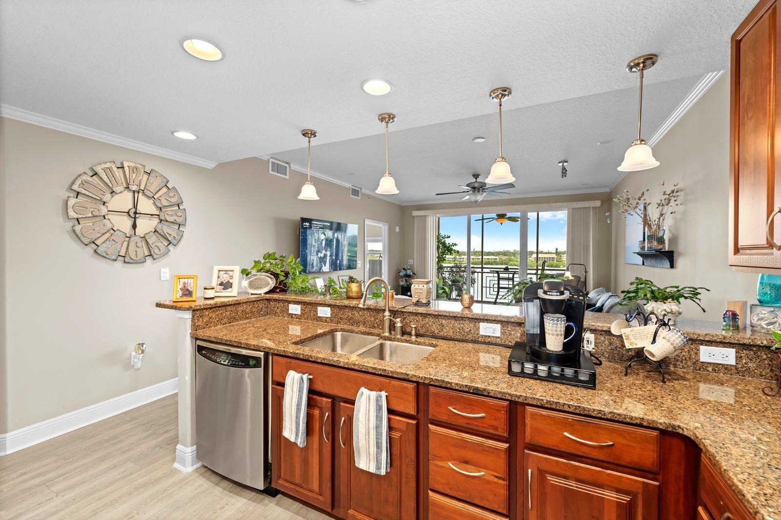 A beautiful breakfast bar with pendant lighting overlooks into the great room.